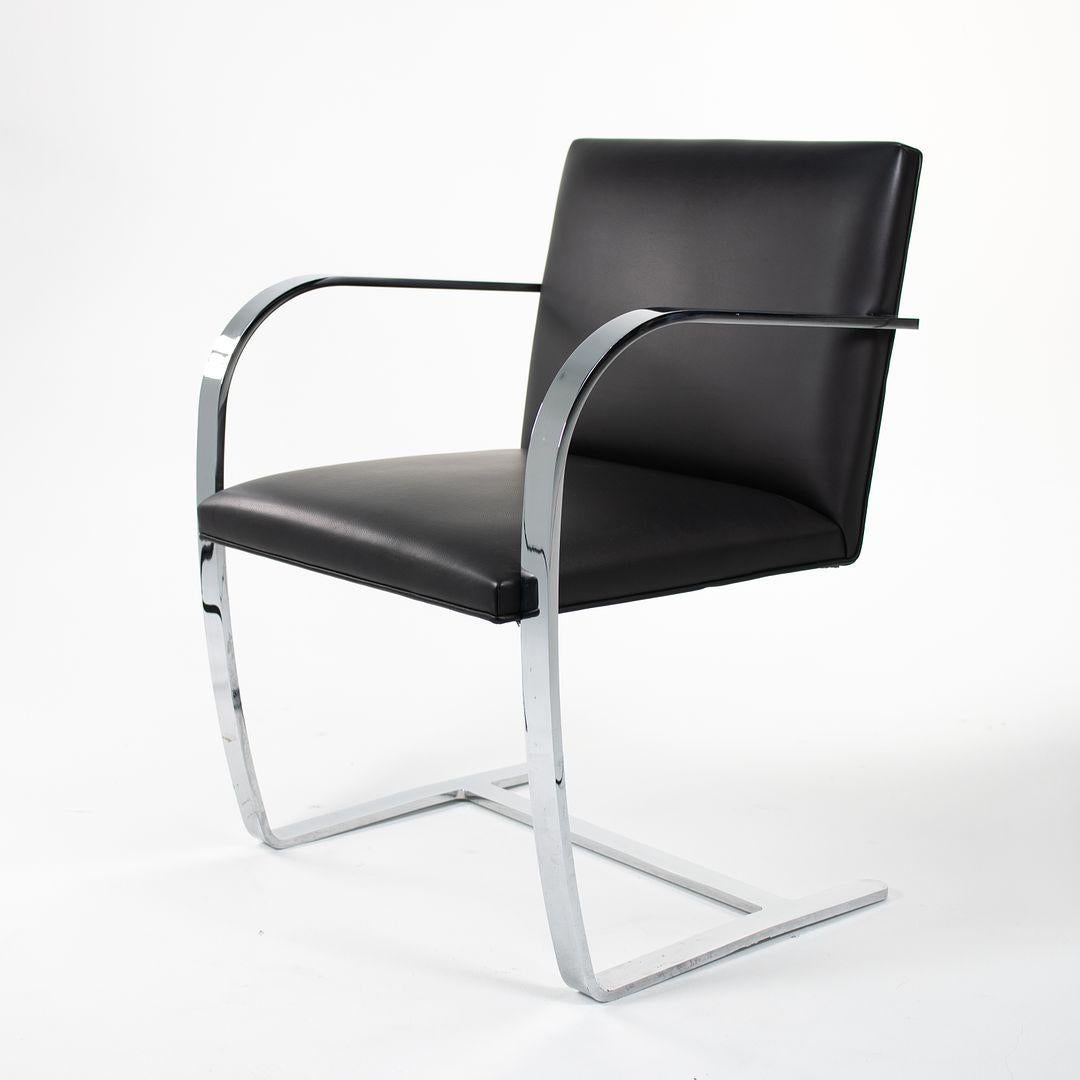This is a Brno Chair, Model 255, originally designed by Ludwig Mies van der Rohe in 1929. This example was manufactured in the United States by Knoll in 2006. It features bent chromed-steel arms, and has a cantilever base. The flat bar construction