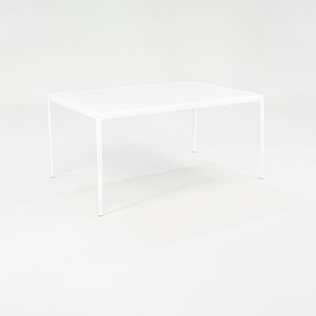 This is a large rectangular dining table, Model 1966-28H, designed by Richard Schultz for his 1966 series for Knoll. This particular example dates to the 2010s. The table features a white powder-coated aluminum frame, and has a white enameled-steel