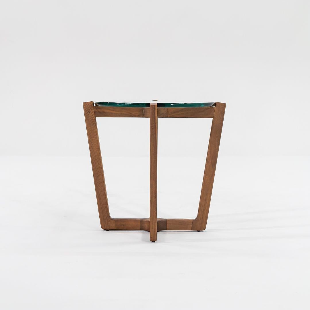 This is an Atlas side table, designed by Brad Ascalon for Design Within Reach in 2013. This particular example was produced by Design Within Reach in the USA in 2016. This table is made of walnut with a glass tabletop. 
 
 The table measures 21.875