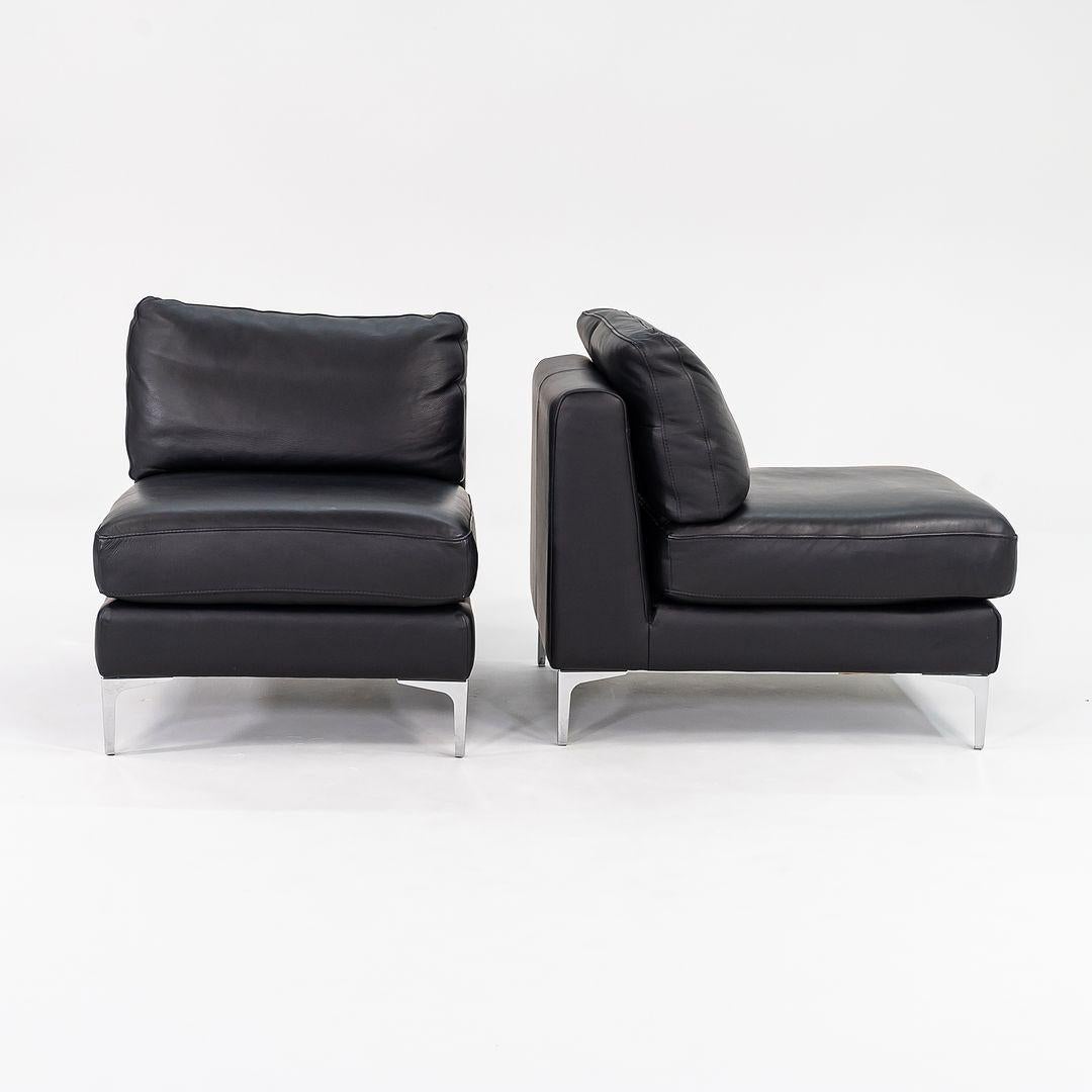 This is a pair of Nicoletti Slipper Lounge Chairs, designed by Giuseppe Nicoletti for Design Within Reach in 2010. These were produced in Italy in 2016 and the listed price includes the pair. They feature black tumbled leather upholstery using only