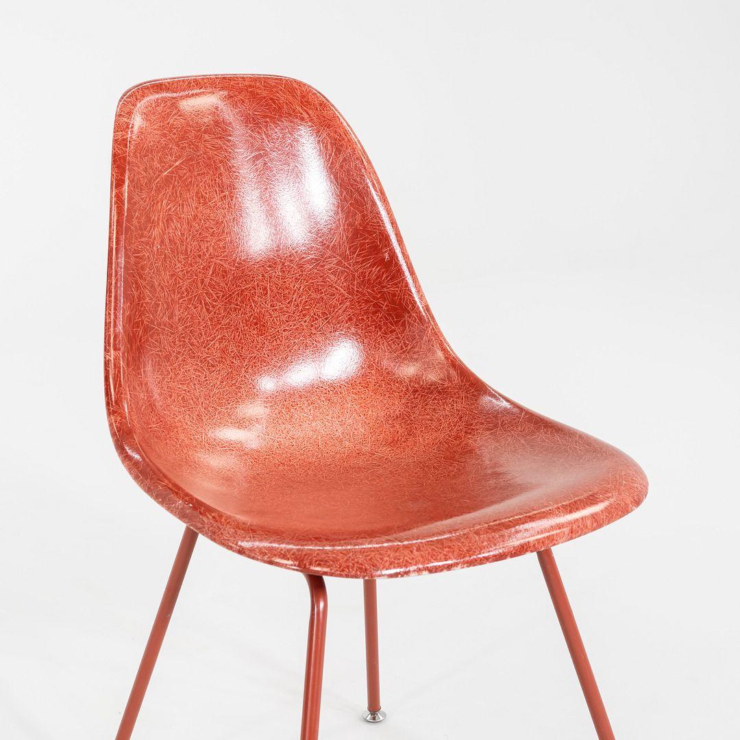 This is a set of three DSX side chairs, originally designed by Ray and Charles Eames in the 1950s. These particular examples were produced by Modernica in Los Angeles, California C. 2018. The chairs are comprised of a red fiberglass shell seat atop