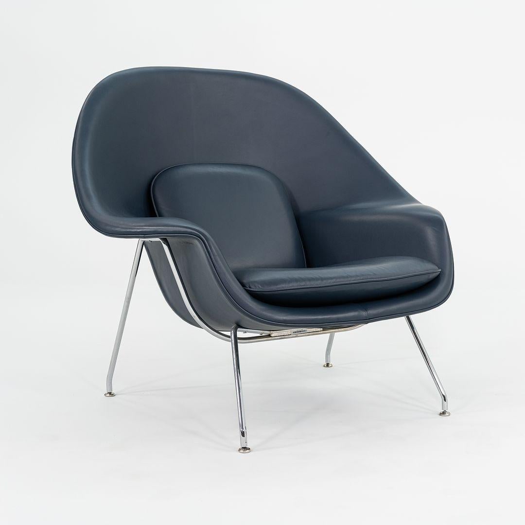 This is an original Womb lounge chair and its accompanying ottoman, Models 70L and 74Y, initially designed by Eero Saarinen for Knoll in 1948. This set was manufactured in the USA in 2019. The design features a seat that is formed of foam-covered