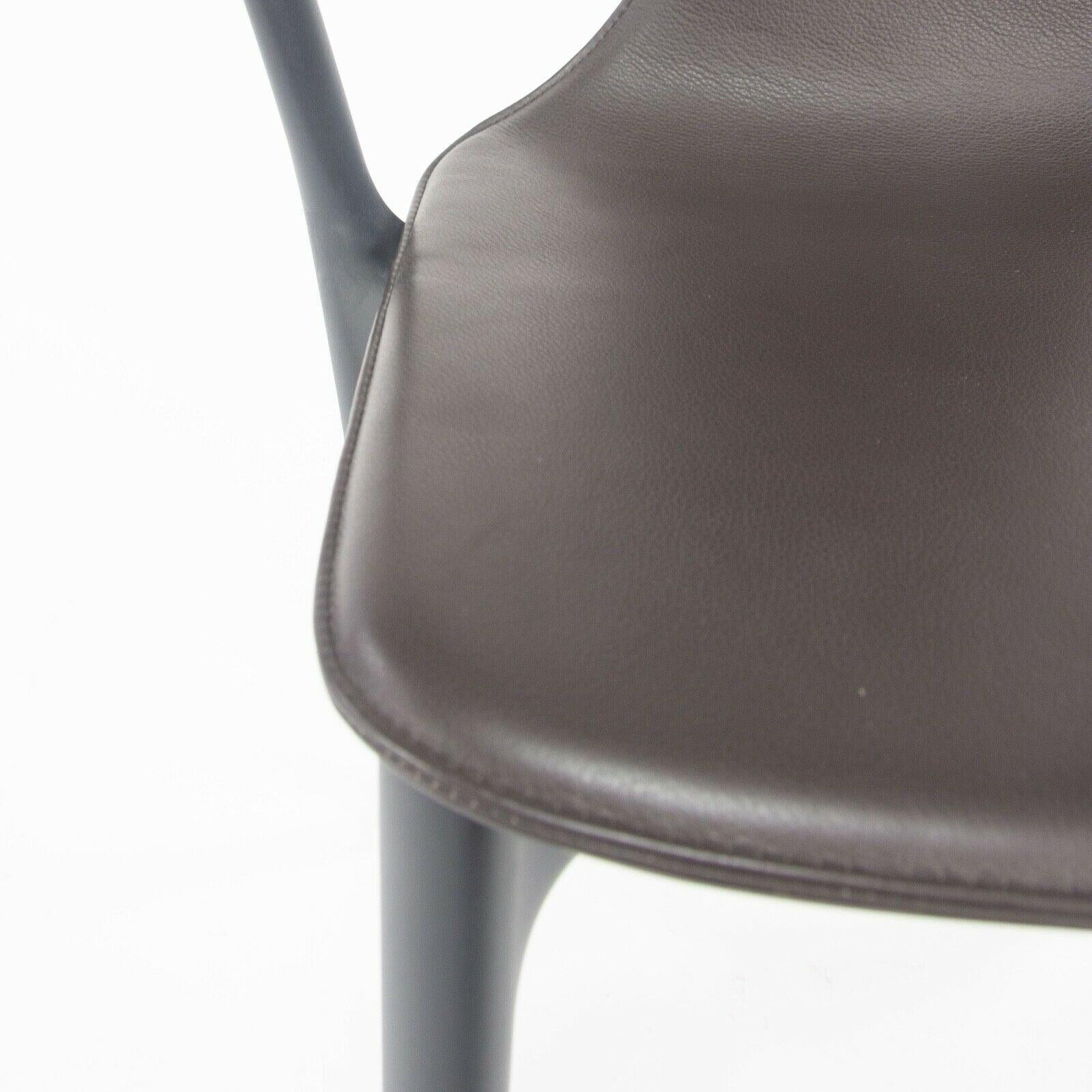Listed for sale is Belleville Armchair designed by Ronan and Erwan Bouroullec and produced by Vitra. This chair was specified with a black plastic frame and brown leather upholstered seat shell. The condition is described as 