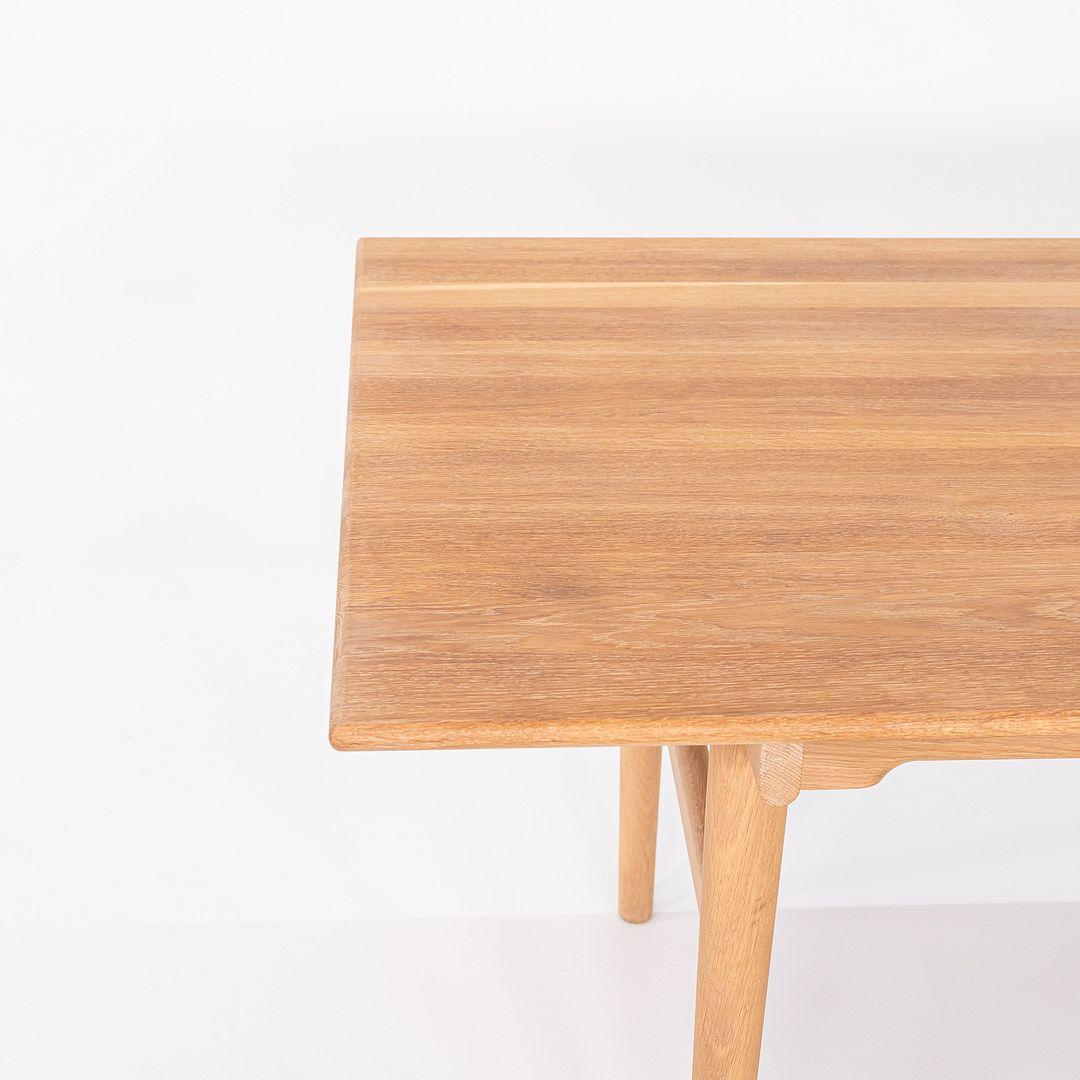 This is a CH327 Dining Table, originally designed by Hans Wegner in 1962. This particular example was produced by Carl Hansen in Denmark C. 2020. The table is made with a solid oak frame and top. 
 

 The table measures 97.75 inches long, 37.25