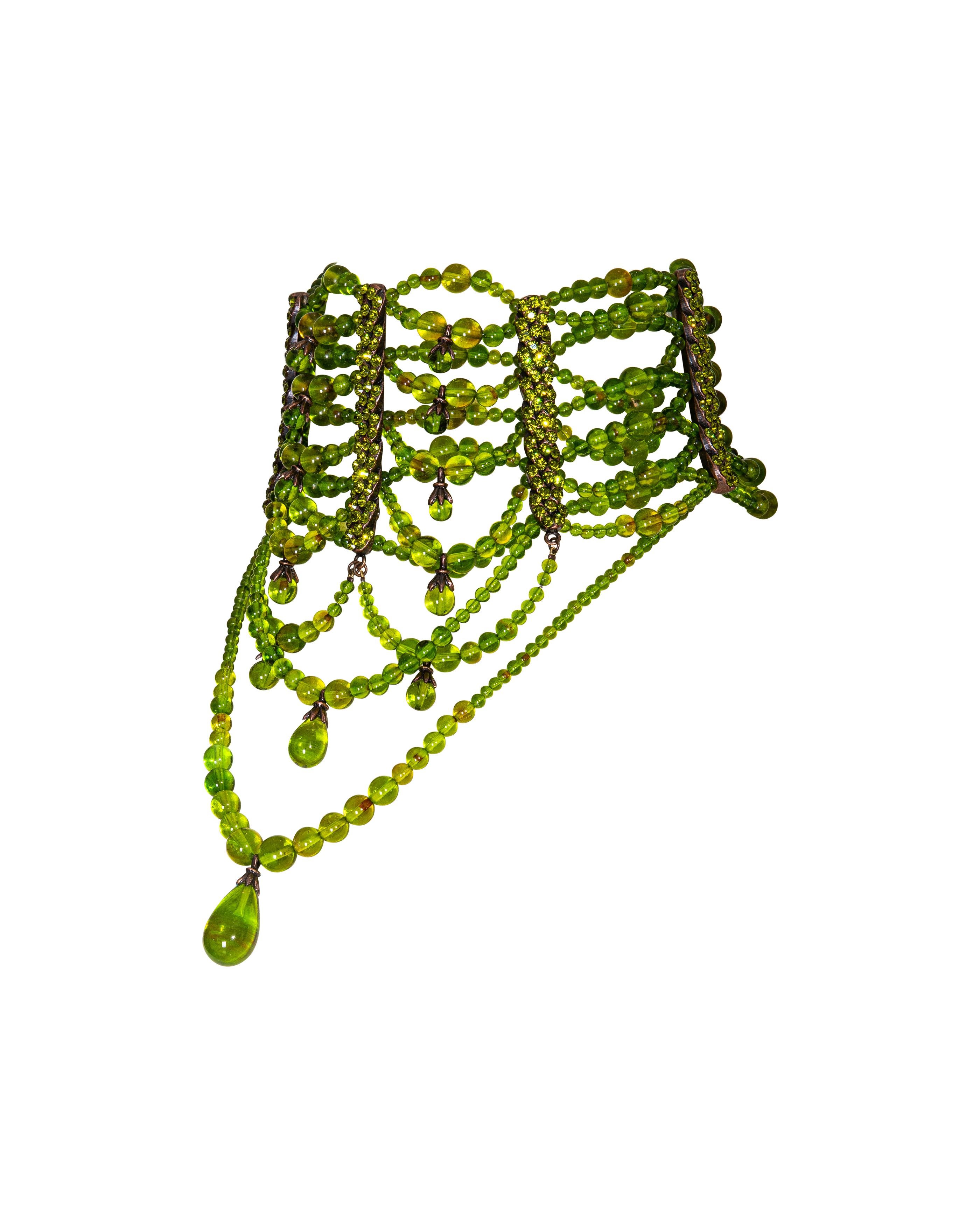 c. A/W 2003 Christian Dior by John Galliano Haute Couture green beaded choker necklace. Deep olive green beaded strands with two green gemstone pendant details. Metallic green rhinestone encrusted front hardware. Dark copper-tone back hardware with