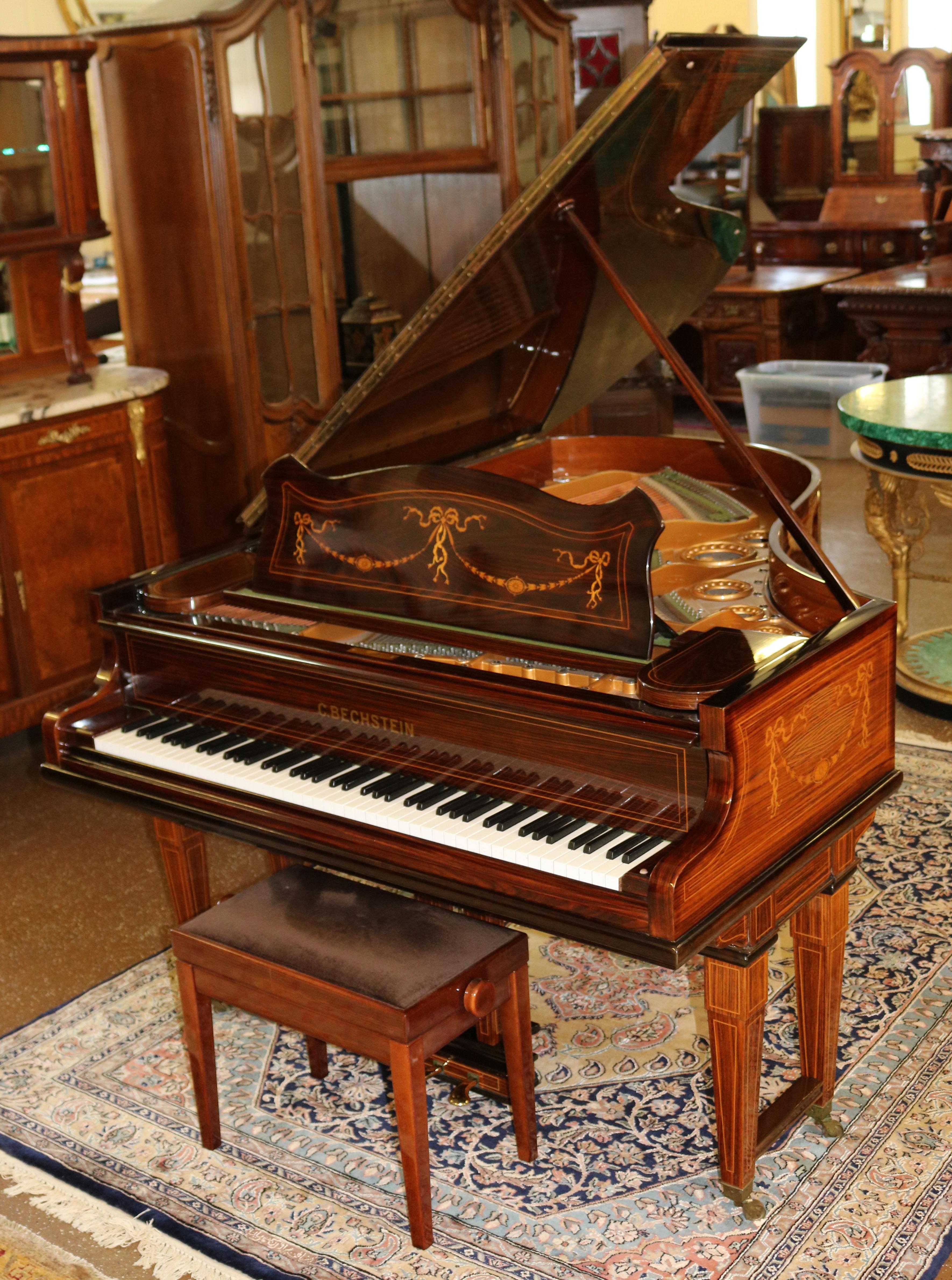 This piano was made by C. Bechstein one of the finest piano makers of all time in Berlin in the early 20th Century. The piano is made of rosewood and is masterfully inlaid with satinwood in the adams style. The grain is absolutely stunning! The
