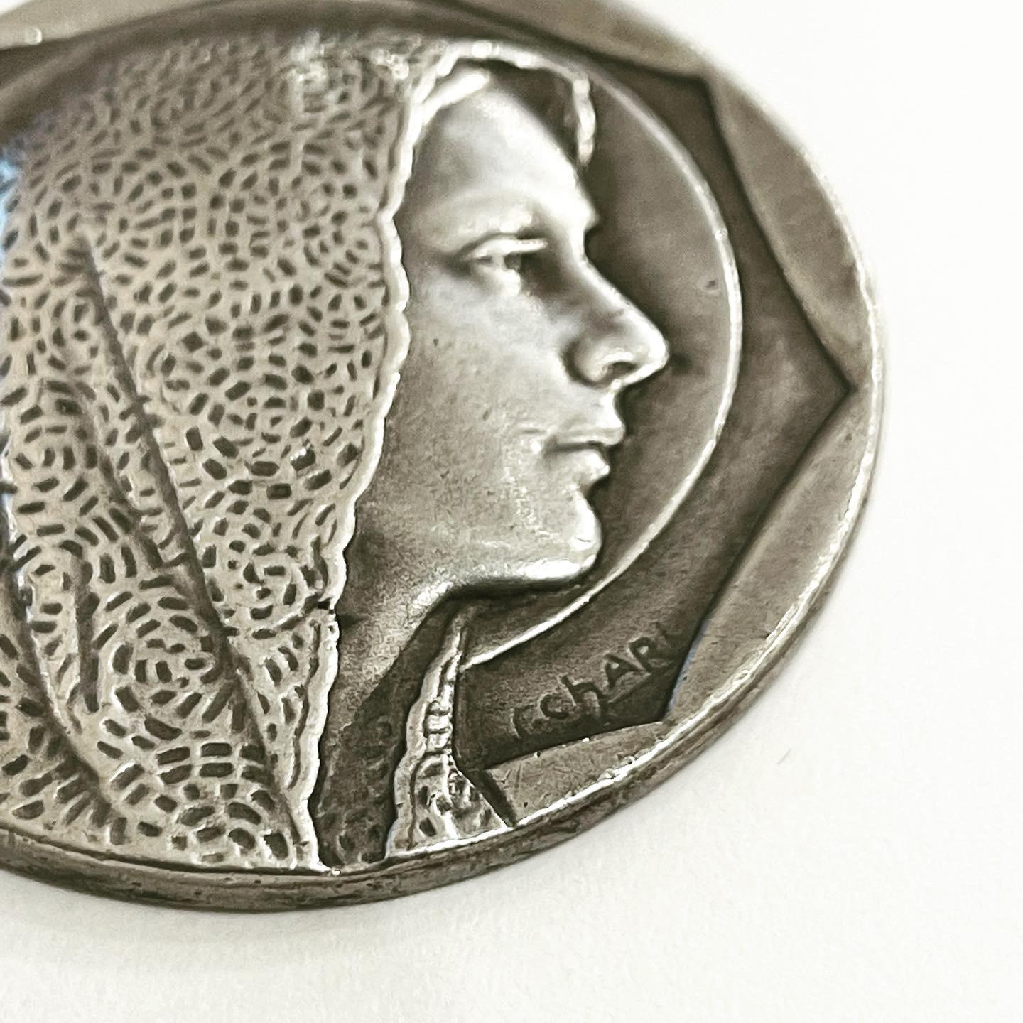 This beautiful C. Charl signed medal pendant is rendered in 800 silver, and features a wonderful engraving of the Virgin Mary. 
Rare and collectible. 
This pendant was made in France in the 1930s. 
Signed and hallmarked: C. Carl and crab for 800
