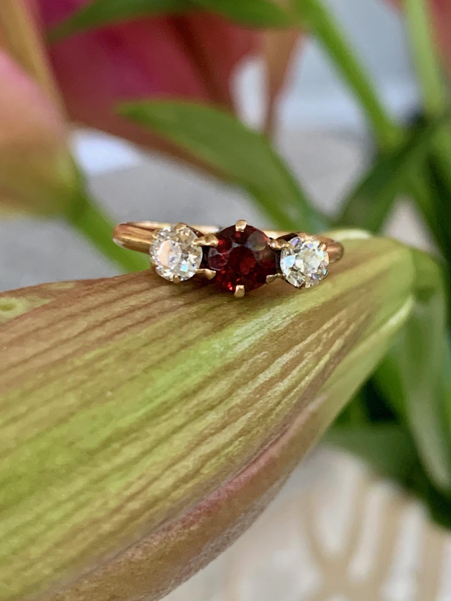 A beautiful Vintage 14k gold ring with large center faceted Garnet stone supported by two Old European cut diamonds.  All stones are prong set

From the C.D. Peacock company.

Size 6 1/2 - this ring is resizable but vendor does not offer sizing