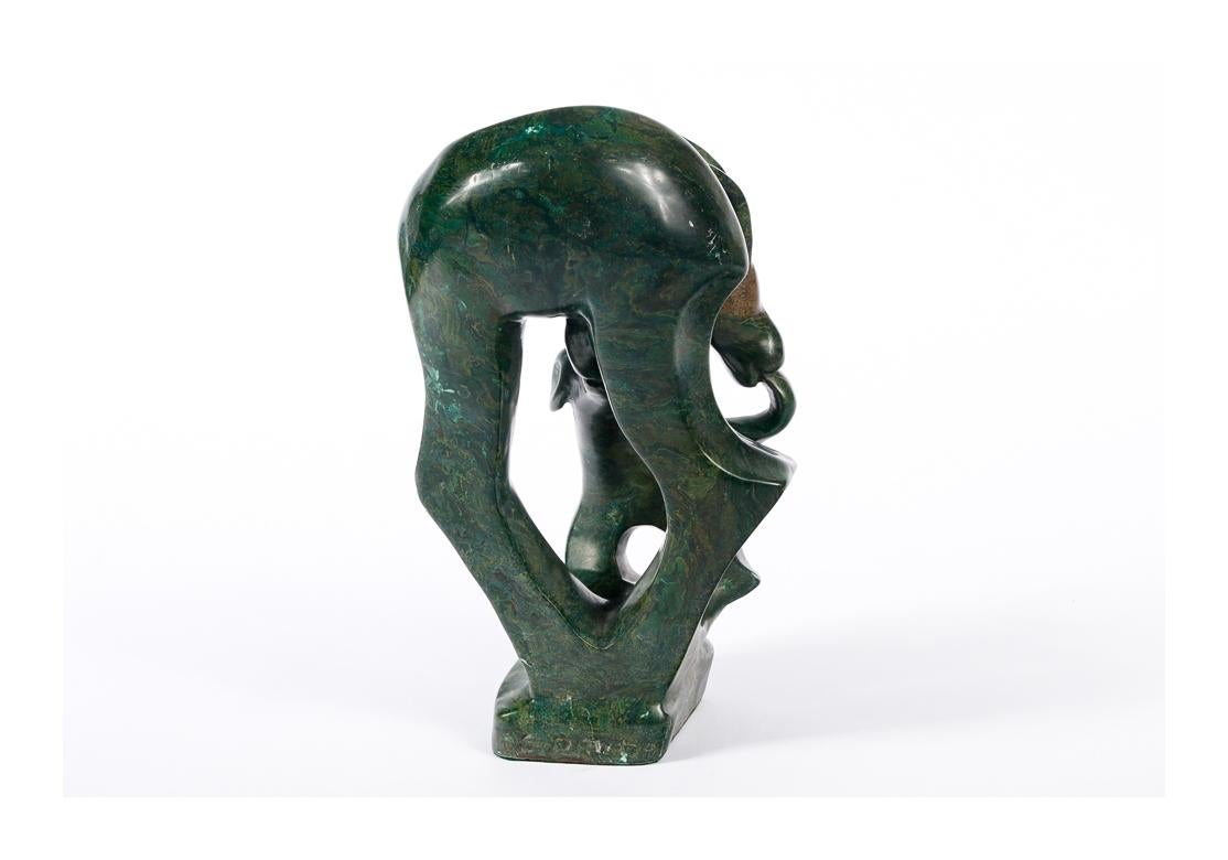 Striking and finely polished Stone Sculpture. Carved and polished deep green stone figural group of a doe nursing her fawn. Brown inclusion on the doe's head. Signed along the back of the base. 
Dimensions: 11