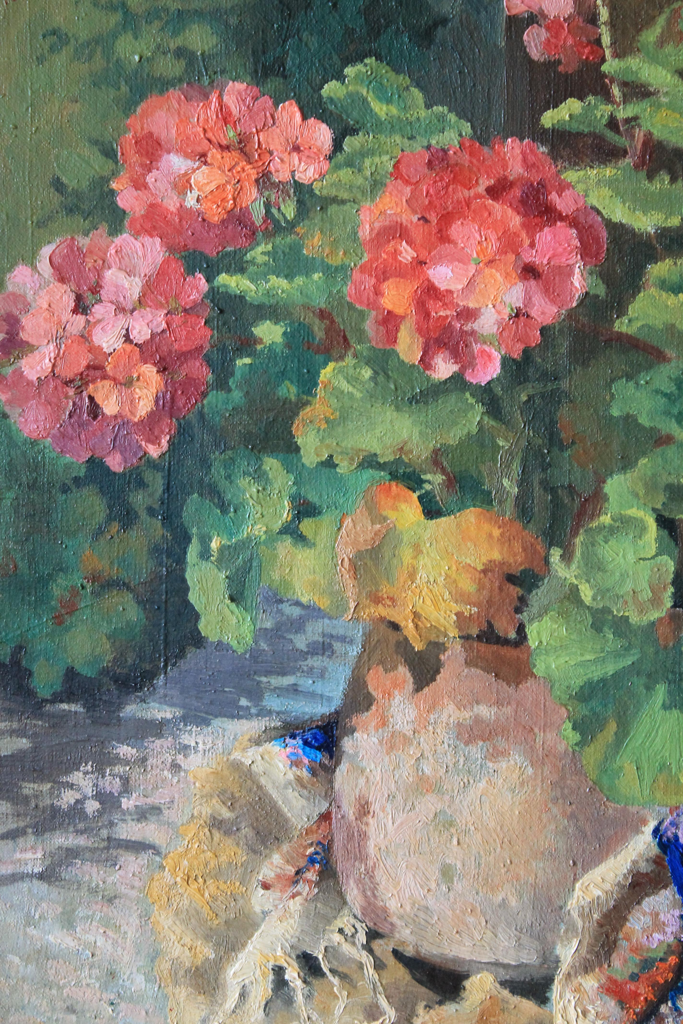 Delightful vintage oil painting on stretched canvas of geraniums in an old terracotta or clay pot, signed in the lower right corner and in it's original frame.  Impressionist geraniums in tones of pinks and reds dance over the canvas amidst gorgeous