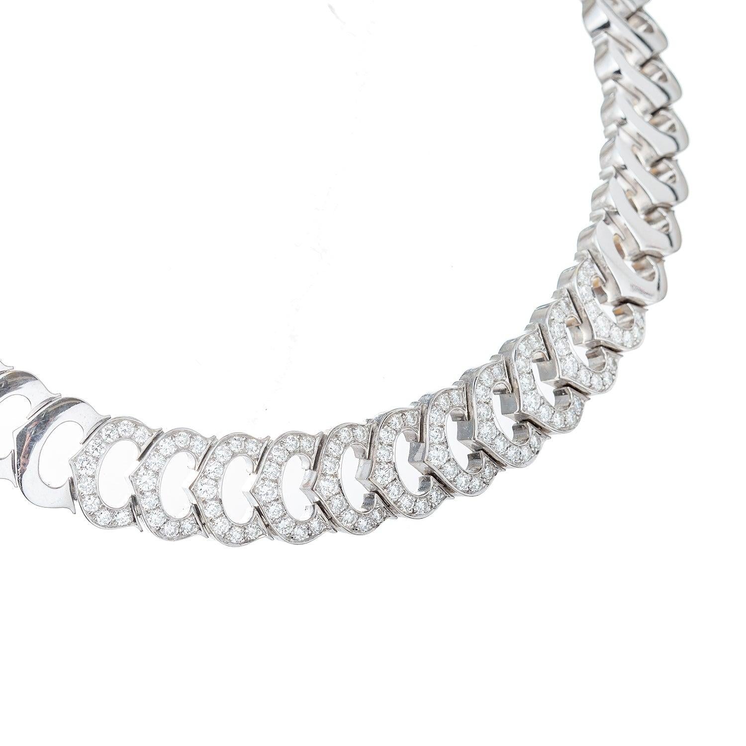 'C' de Cartier collar necklace, featuring horizontally joined 'C' logo motif links in polished 18k white gold accented by eleven links at center set with round brilliant-cut diamonds.

99 diamonds weighing approximately 4.29 total carats.  Signed