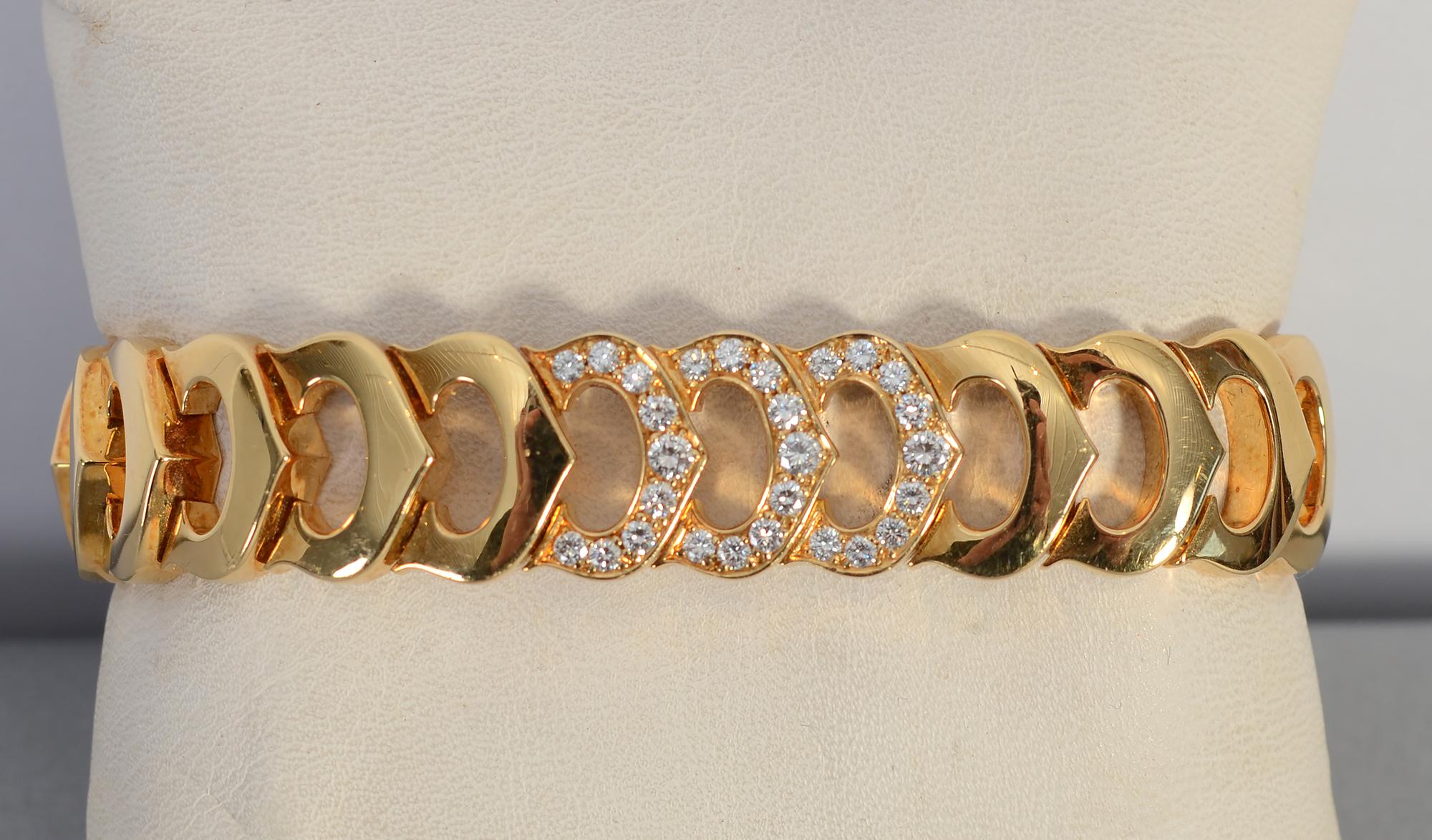 Elegant C de Cartier gold bracelet with 27 diamonds in the central three links. The bracelet is 7 inches in wearable length and 9/16