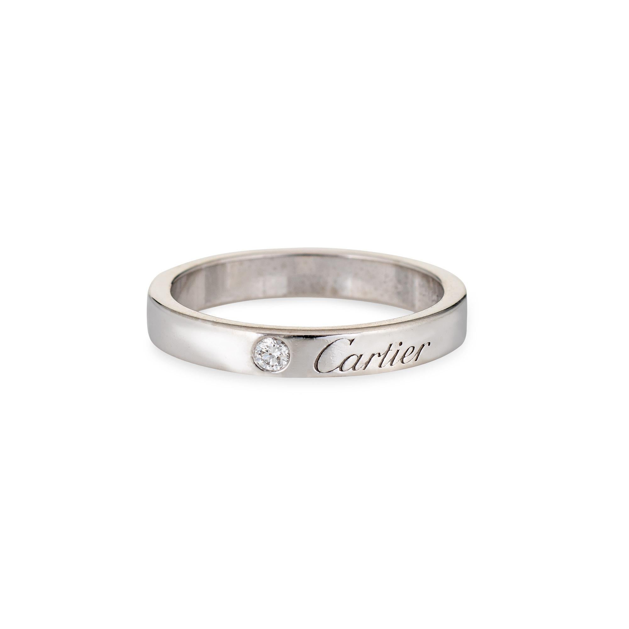 Pre-owned C De Cartier wedding ring crafted in platinum.  

One estimated 0.03 carat diamond is set into the band (estimated at F-G color and VVS2 clarity).
The Cartier ring is set with a small diamond next to the Cartier script. The band measures