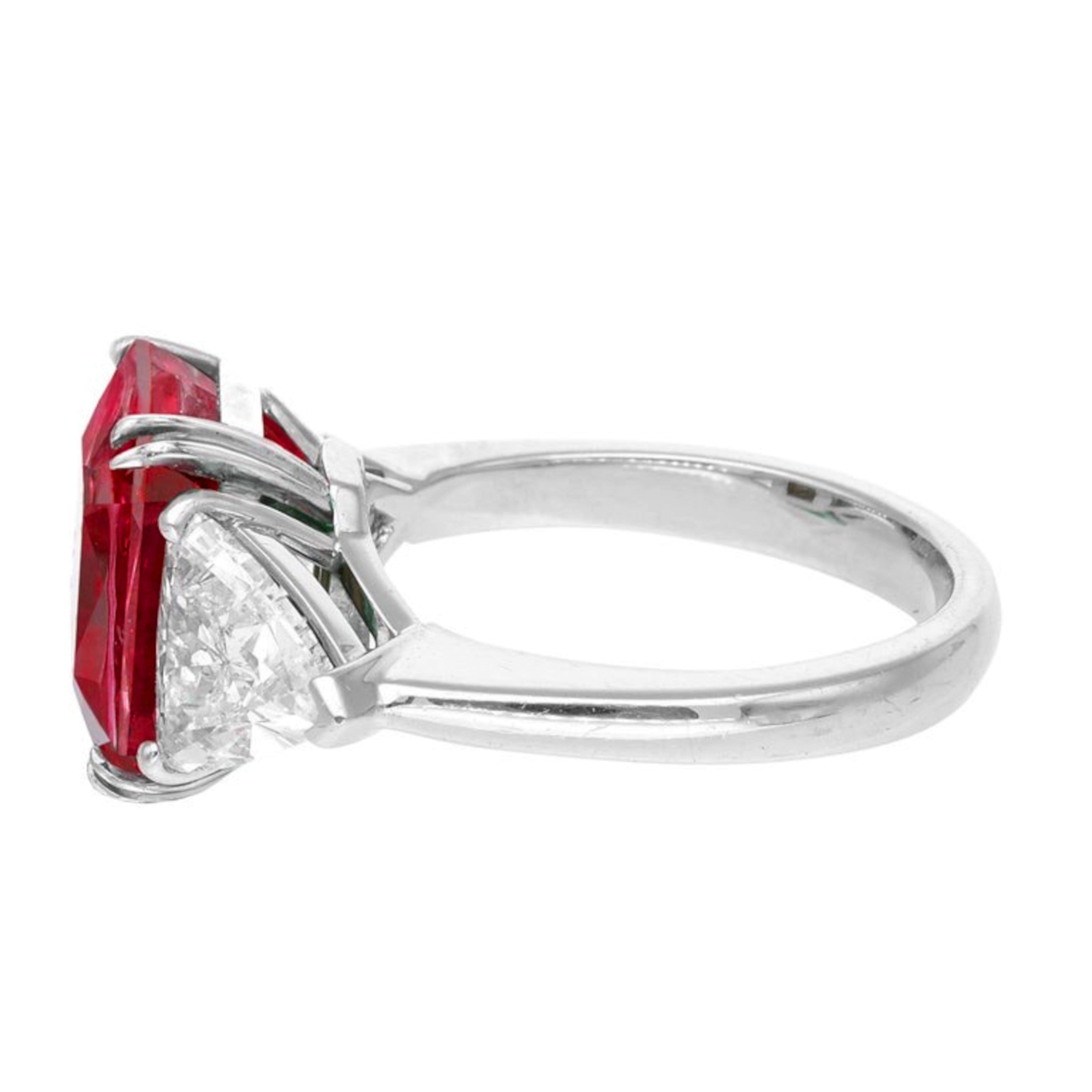 exquisite C. Dunaigre ring that showcases a stunning 4.11-carat certified Mozambique untreated ruby, beautifully set in luxurious platinum. This remarkable piece features two elegant trapezoidal diamonds of exceptional VVS clarity and D color,