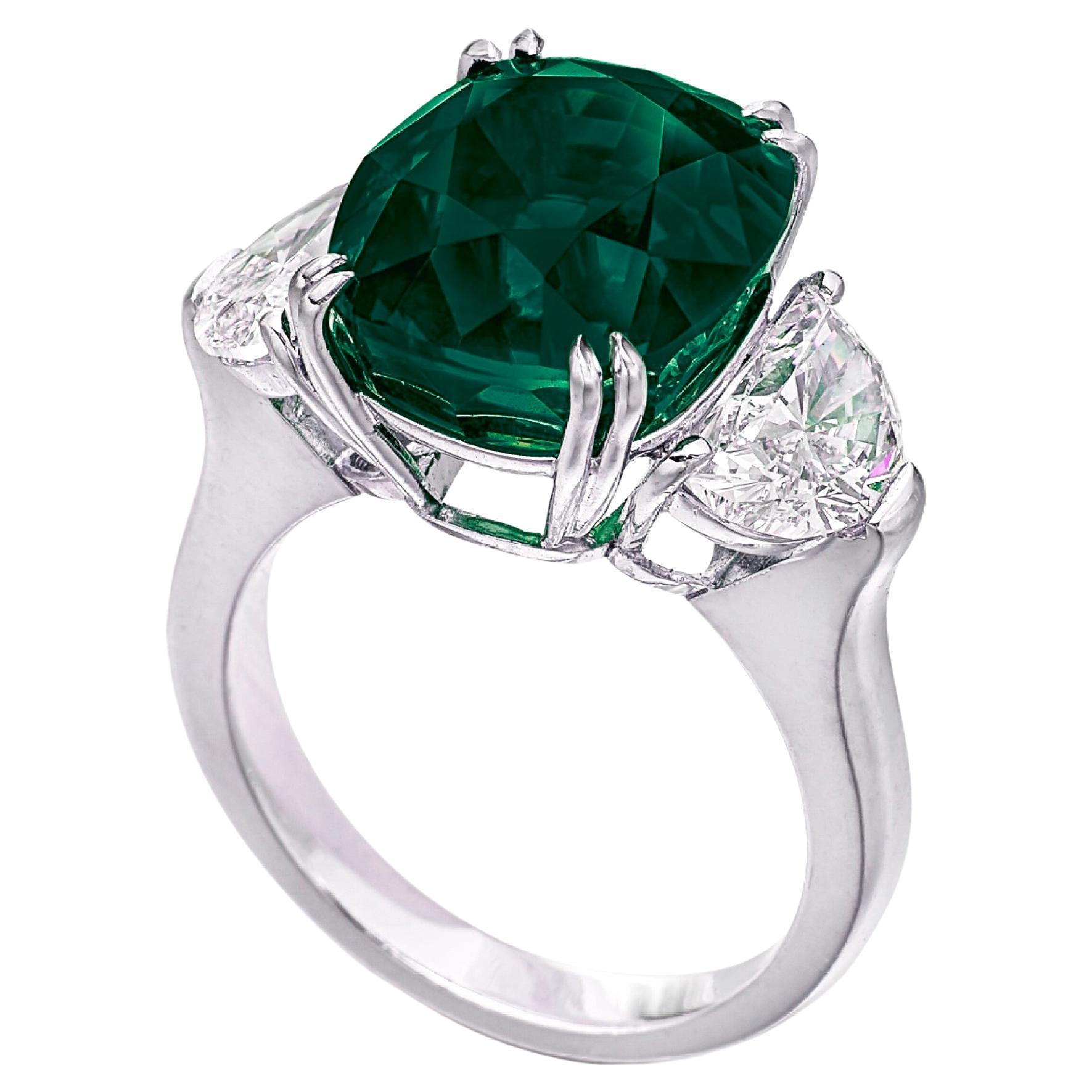 An exquisite 5.41 carat cushion minor oil emerald certified by GRS 
zambian origin

side diamonds are half moons and weight 1 carat e color vvs clarity 

set in solid platinum

 color is vivid green