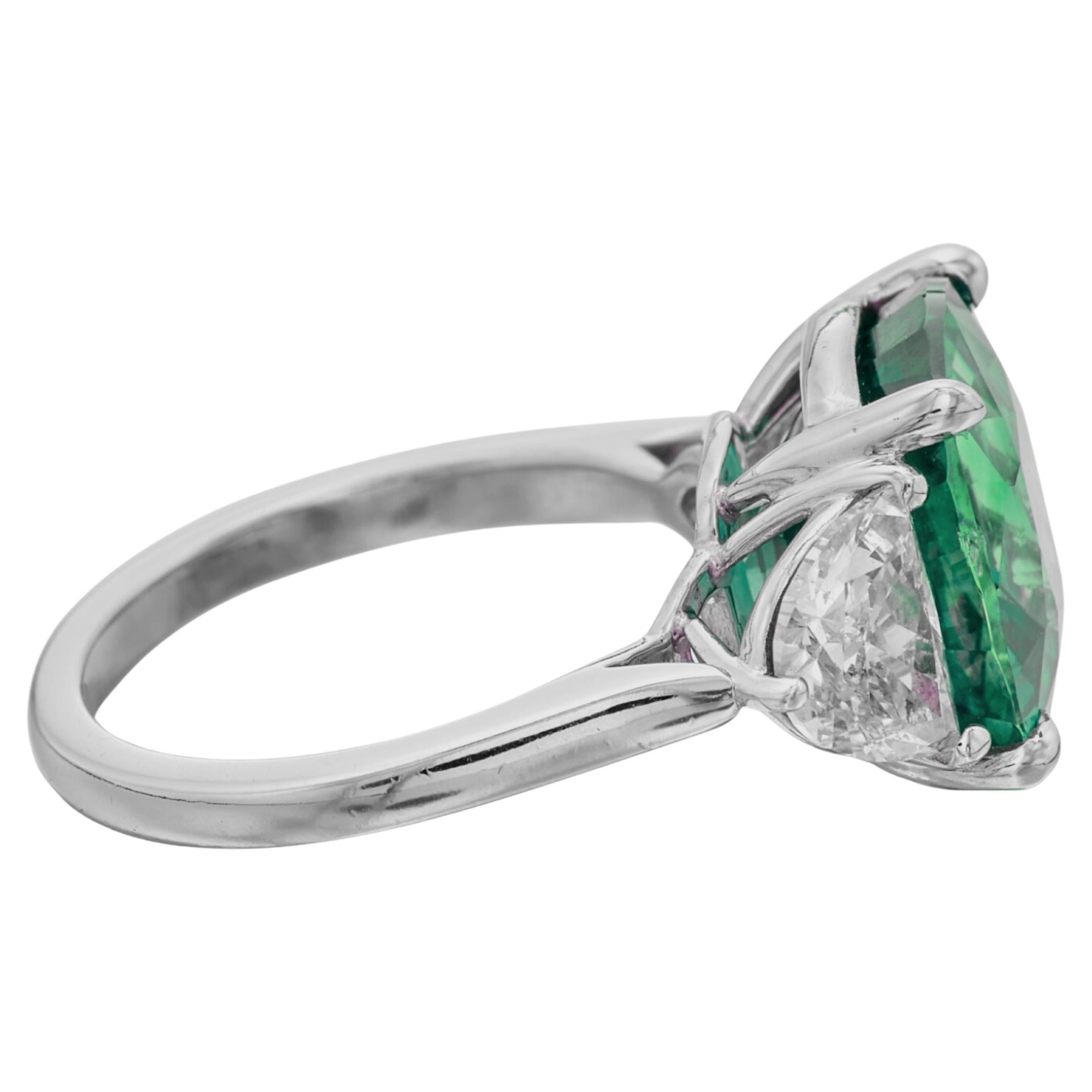 Exquisite C.Dunaigre-Certified Colombian Emerald Ring
This exceptional 6.56-carat cushion-cut Colombian emerald, C.Dunaigre certified with minor oiling, takes center stage in a design that radiates luxury. Flanked by trios of bullet-cut diamonds on