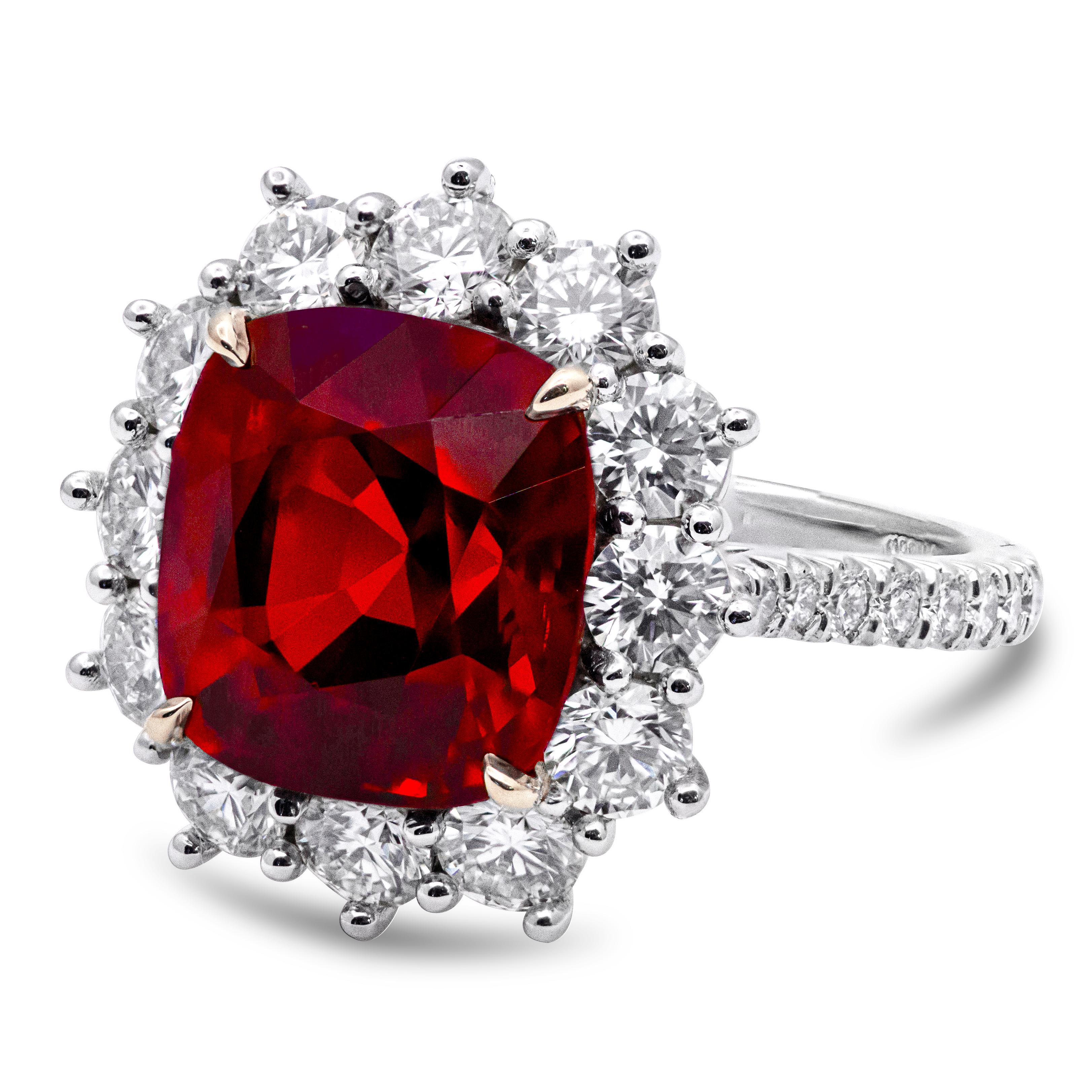 A marvelous fashion ring features a C. Dunaigre Certified Cushion Cut Natural Red Spinel weighing 6.92 carats, Burma Origin, with no indications of heat treatment.  Surrounded by a row of brilliant round diamonds and accented with round diamonds