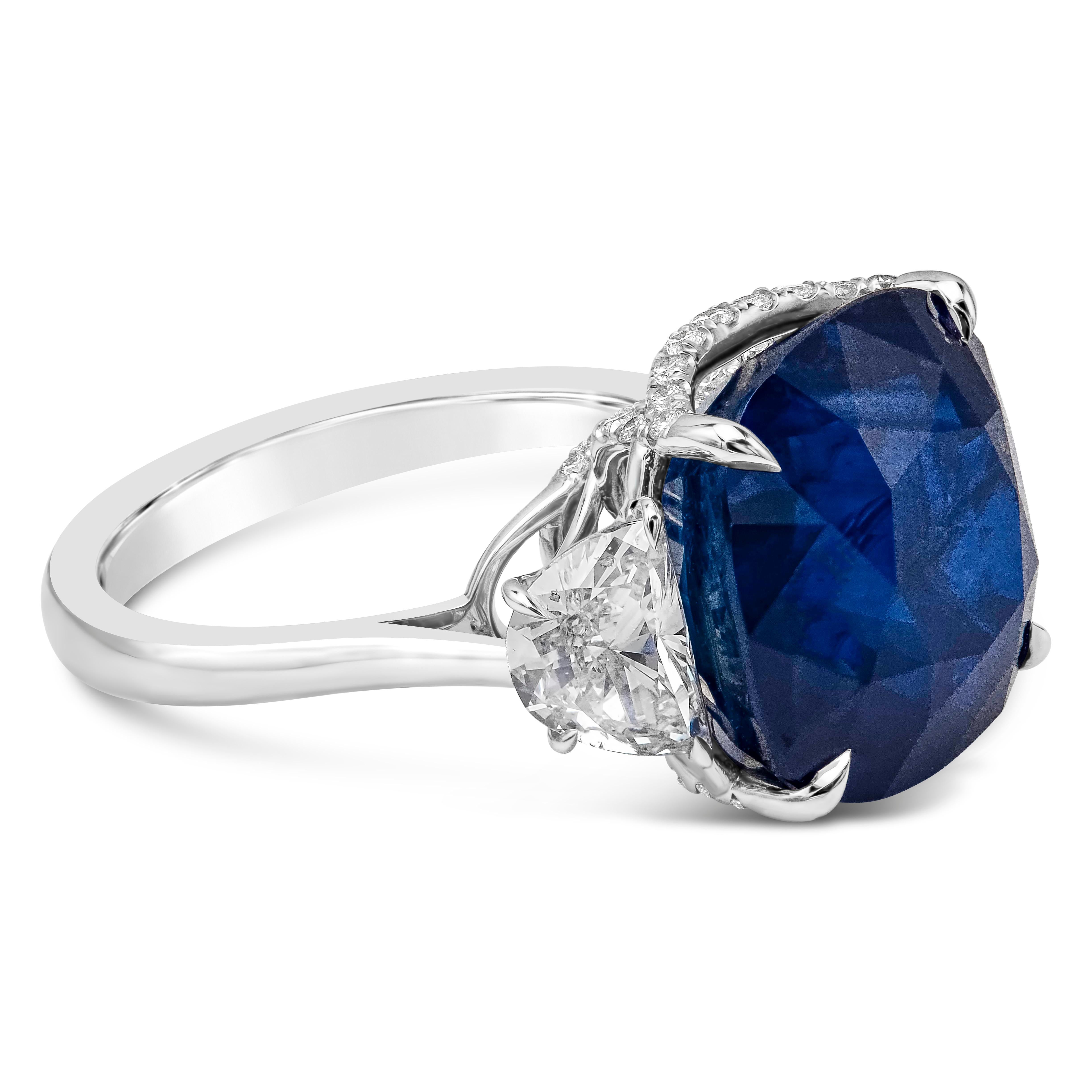 Well crafted three stone engagement ring featuring a beautiful and vibrant 15.68 carat cushion cut sapphire gemstone certified by C. Dunaigre as intense blue color, Ceylon/ Sri Lanka origin. Flanking the center gemstone are half moon diamonds