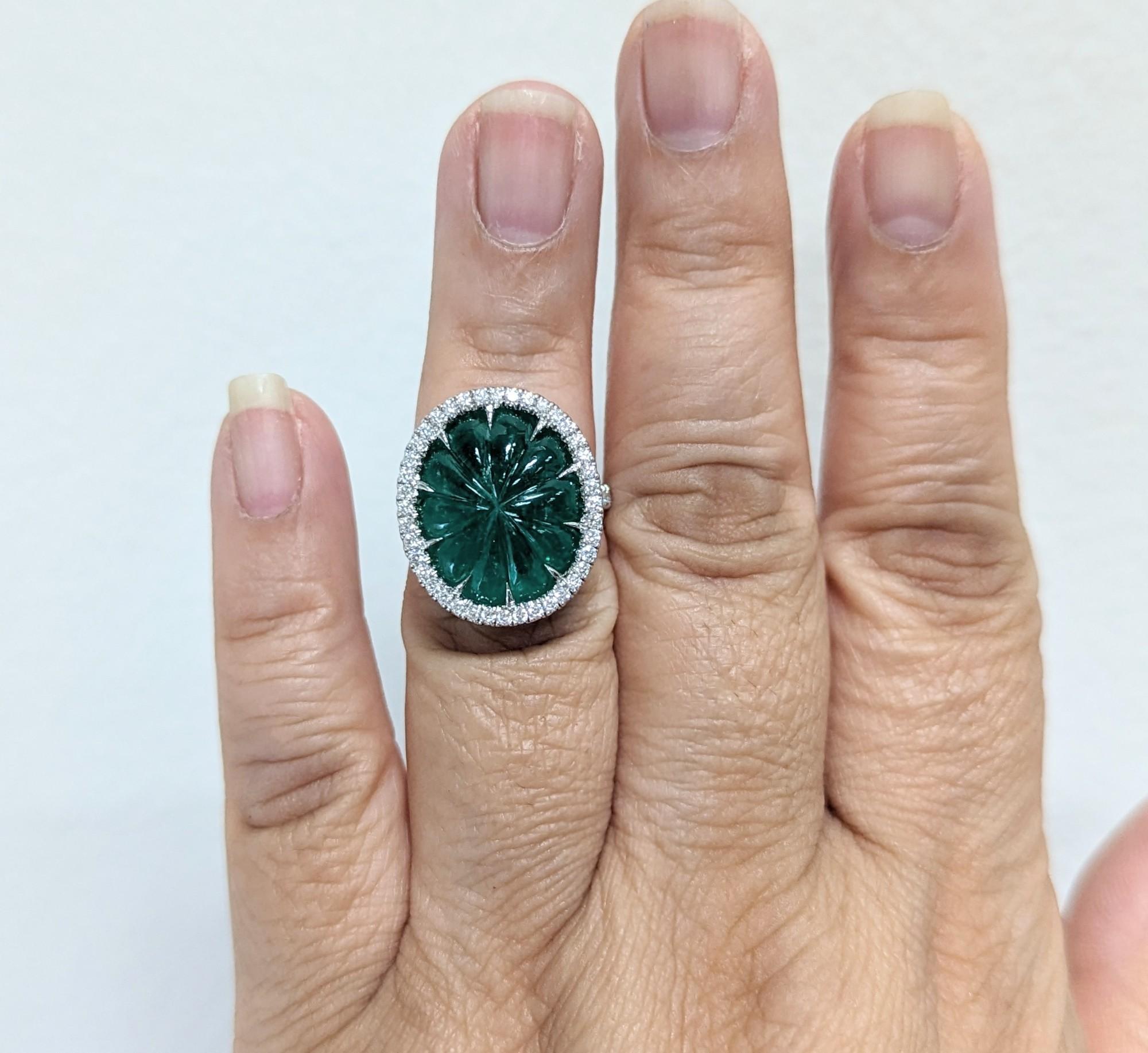 Absolutely stunning 12.69 ct. C. Dunaigre certified Colombian oval emerald with 0.79 ct. good quality white diamond rounds.  Handmade in platinum.  Ring size 6.5.  Certification is included.