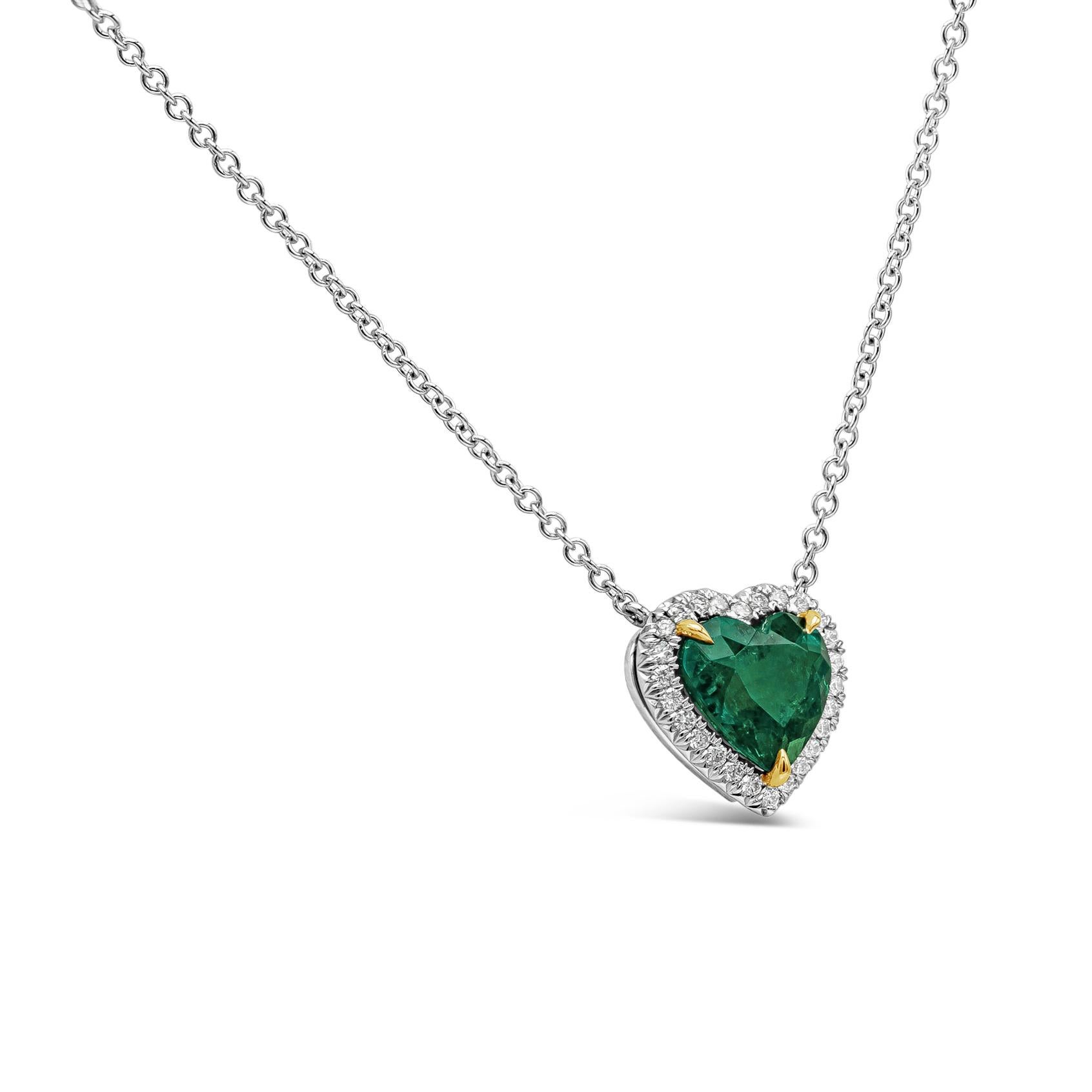 A rare piece of jewelry showcasing a 1.68 carat vivid color green emerald in a heart shape, surrounded by a single row of round brilliant diamonds set in platinum.  Pendant is suspended on an 18 inch 18k white gold chain. Center emerald is certified