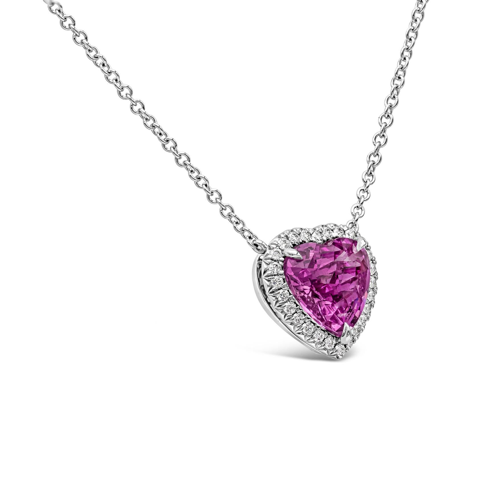 A rare piece of jewelry showcasing a 2.92 carat vivid pink sapphire in a heart shape, surrounded by a single row of round brilliant diamonds. Pendant is suspended on an 18 inch 18k white gold chain. Center sapphire is certified by C. Dunaigre.