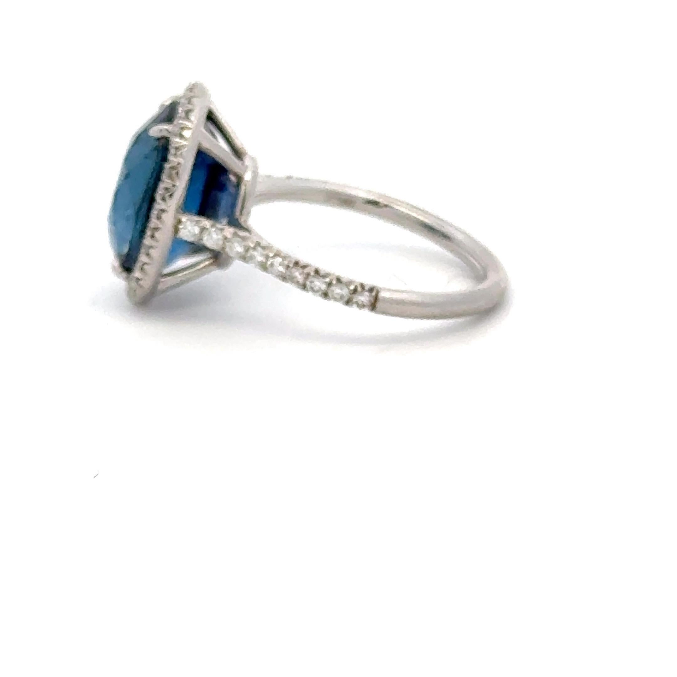 Set in Platinum this exquisite ring showcases a stunning 6.50 carat oval-cut deep blue sapphire, certified by renowned gemological laboratory C. Dunaigre, ensuring its authenticity and quality. The rich, velvety hue of the Sapphire is perfectly