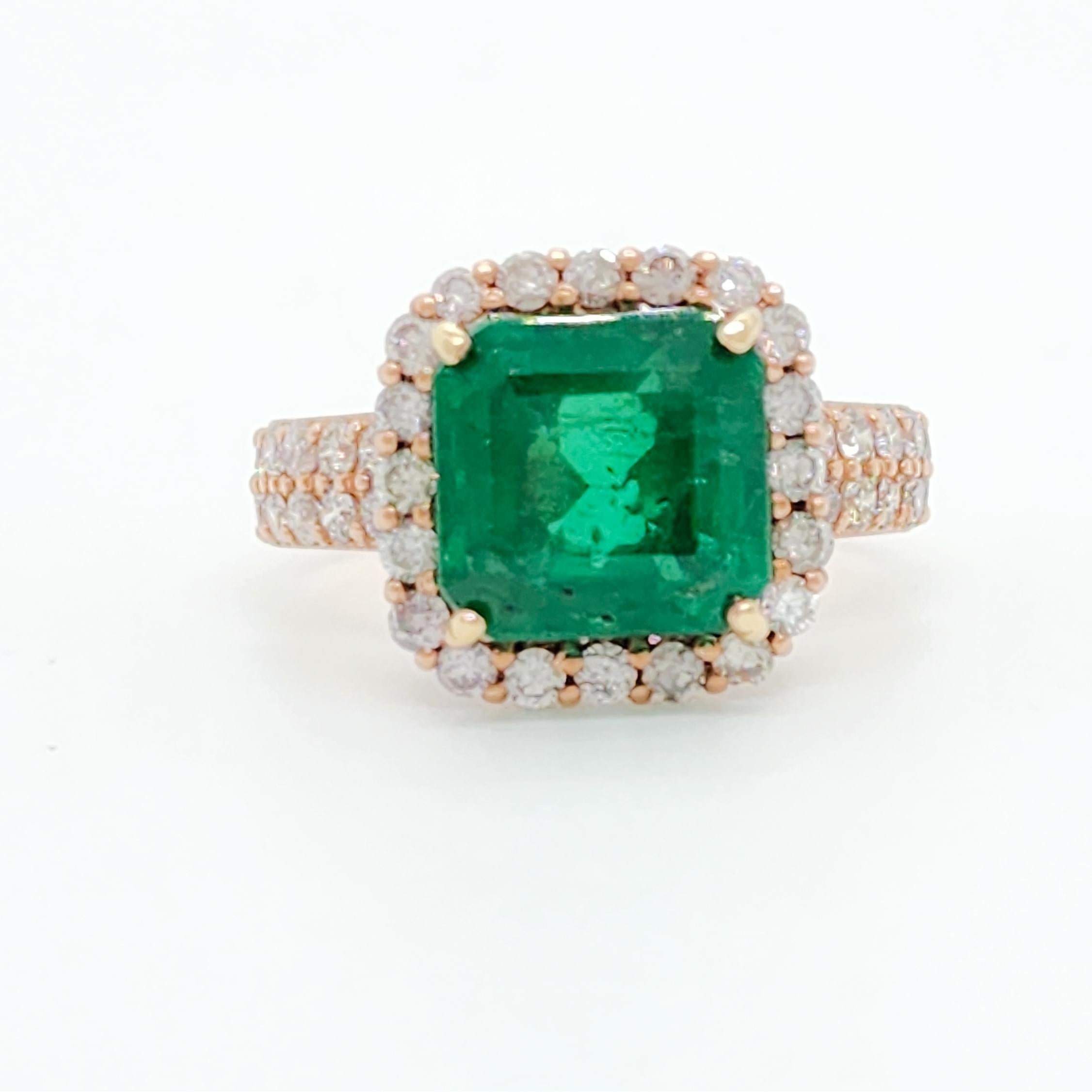 Gorgeous 4.33 ct. bright green Zambian emerald octagon with good quality white diamond rounds.  Handmade in 18k rose gold.  Ring size 7.75.
