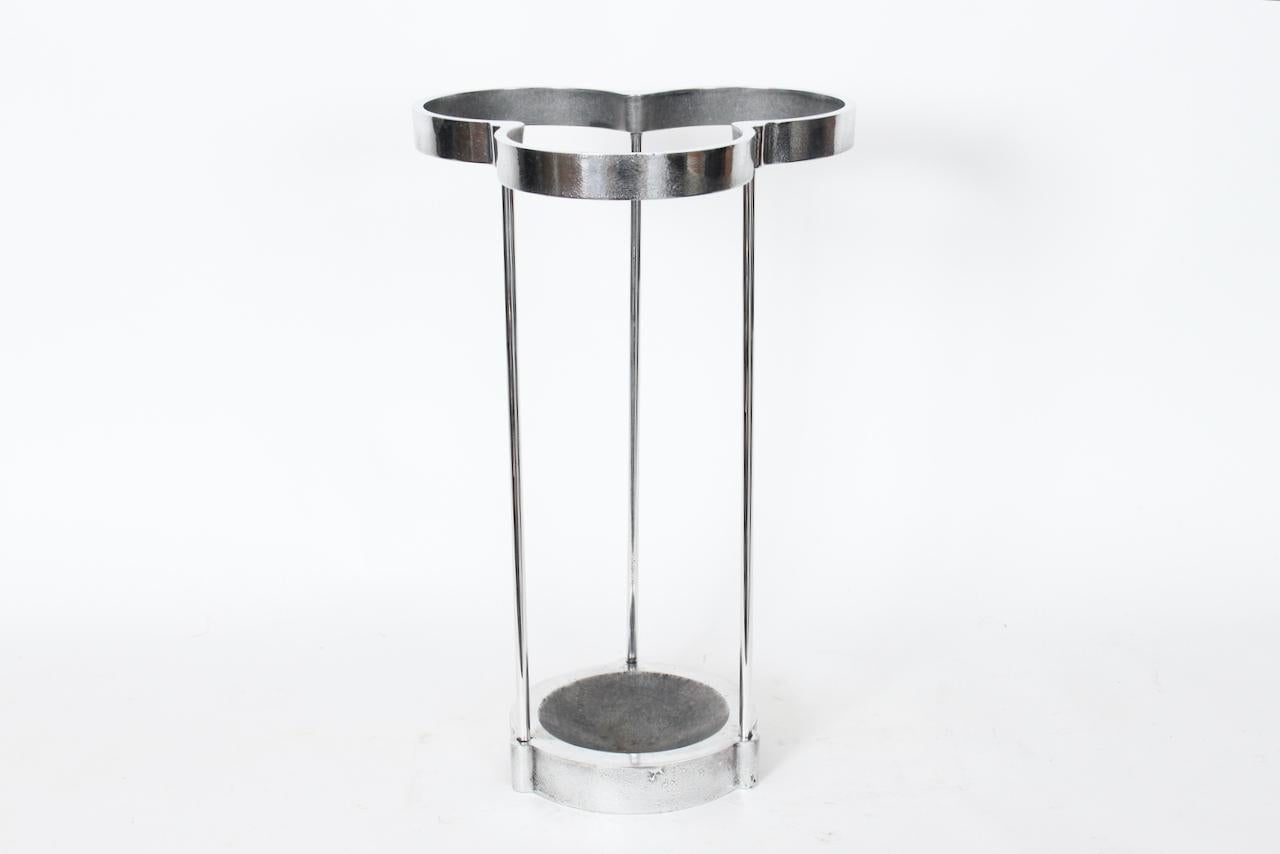 Emanuela Frattini Magnusson Aluminum Trefoil Umbrella Stand, Cane Stand. Featuring a balanced, reinforced open three stem framework, three leaf clover opening with raised, circular 8D base and concave receptacle area for umbrellas and canes. Sturdy.