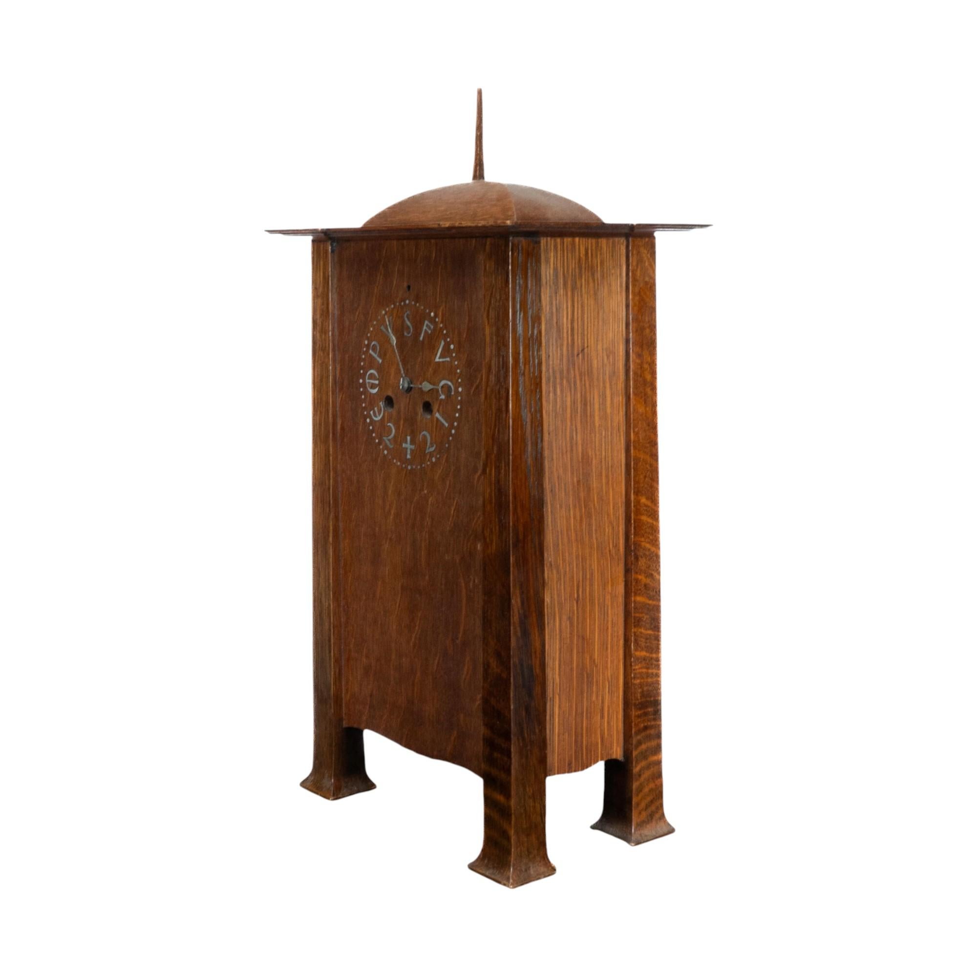C. F. A. Voysey (1857-1941). A rare Arts and Crafts oak mantel clock, the dial inlaid with pewter letters 'Tempus Fugit', enclosing a simple clock movement with striker and pendulum. c.1902.
Voysey first designed a clock of this form with a
