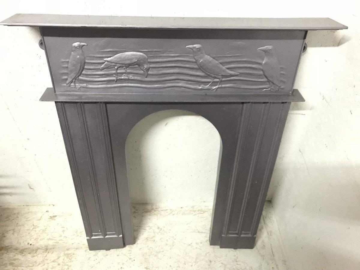 C.F.A Voysey, probably made by George Wright.
A rare cast iron fireplace with feeding character crows dining in a field, reminiscent of gentleman in tails.
The fireplace has been professionally painted silver at some point which I was happy to