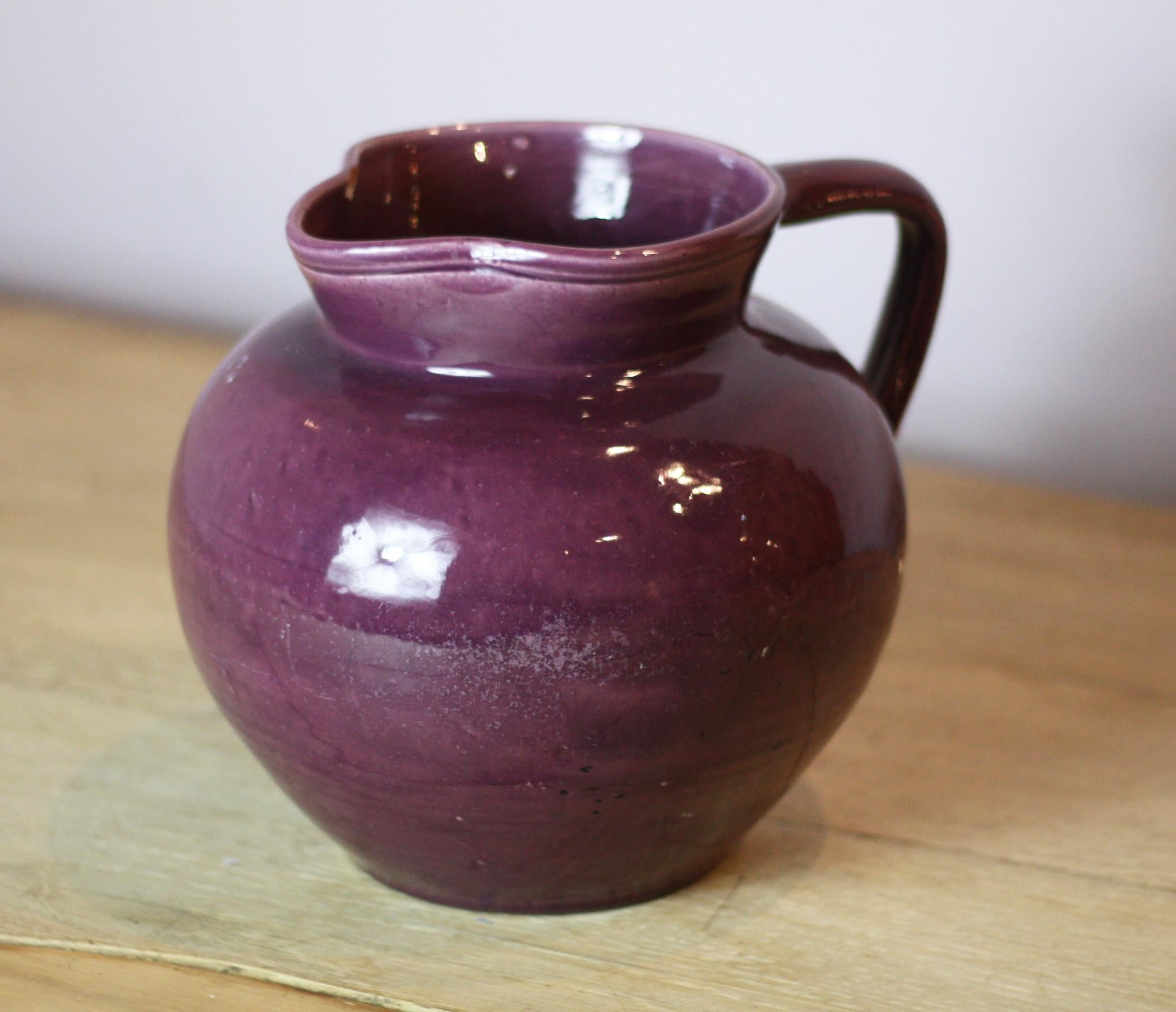 An early Arts & Crafts glazed ceramic jug, by C H Brannam Barum pottery Barnstaple dated 1913, wonderful purple glaze.
