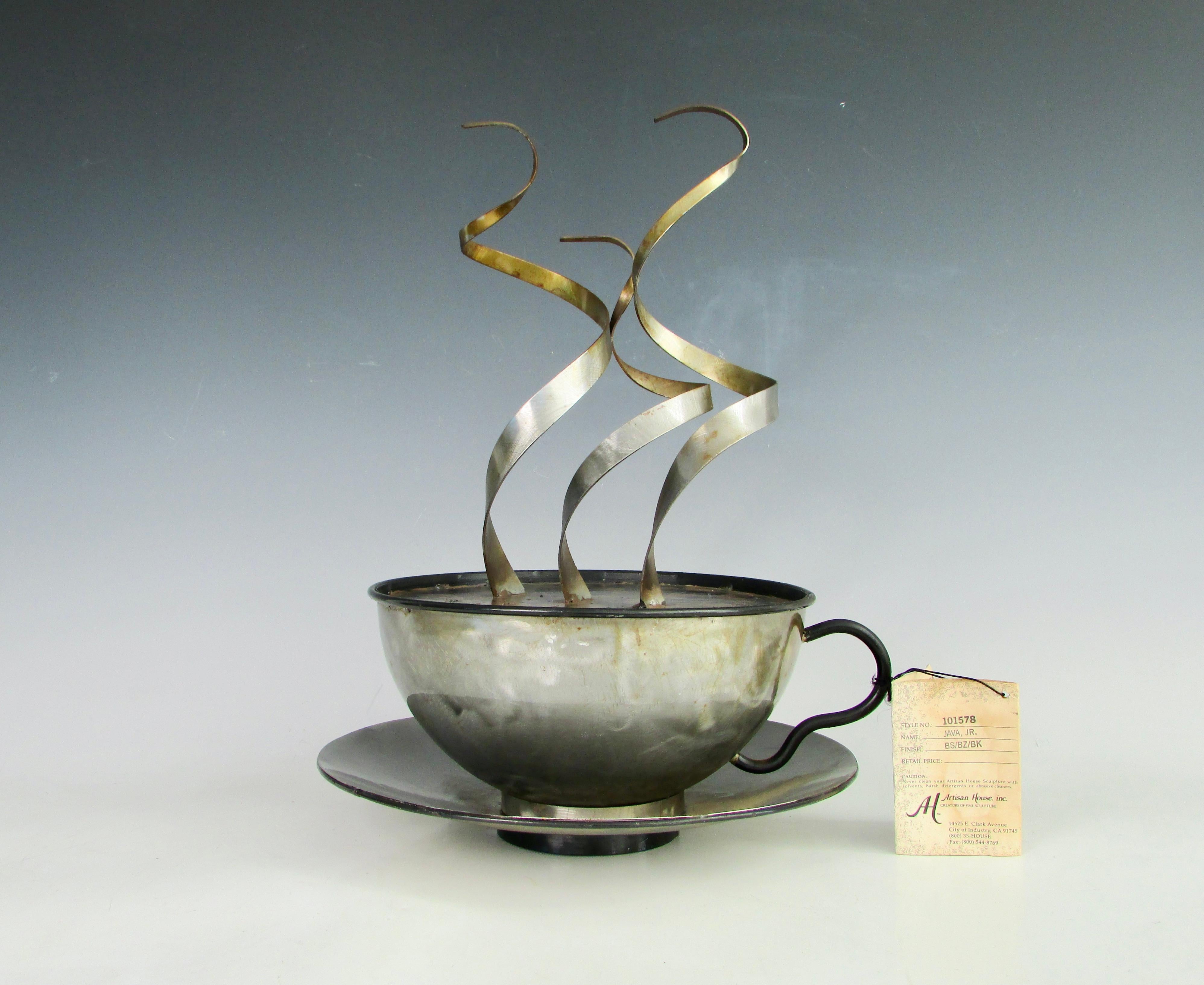 Large C Jere coffee cup with stylized steam wafting from it. Any barista would be proud to own. With original string tag.
Which reads
Under direction of our studios master sculptor leading artists work in concert to create the C Jere collection.