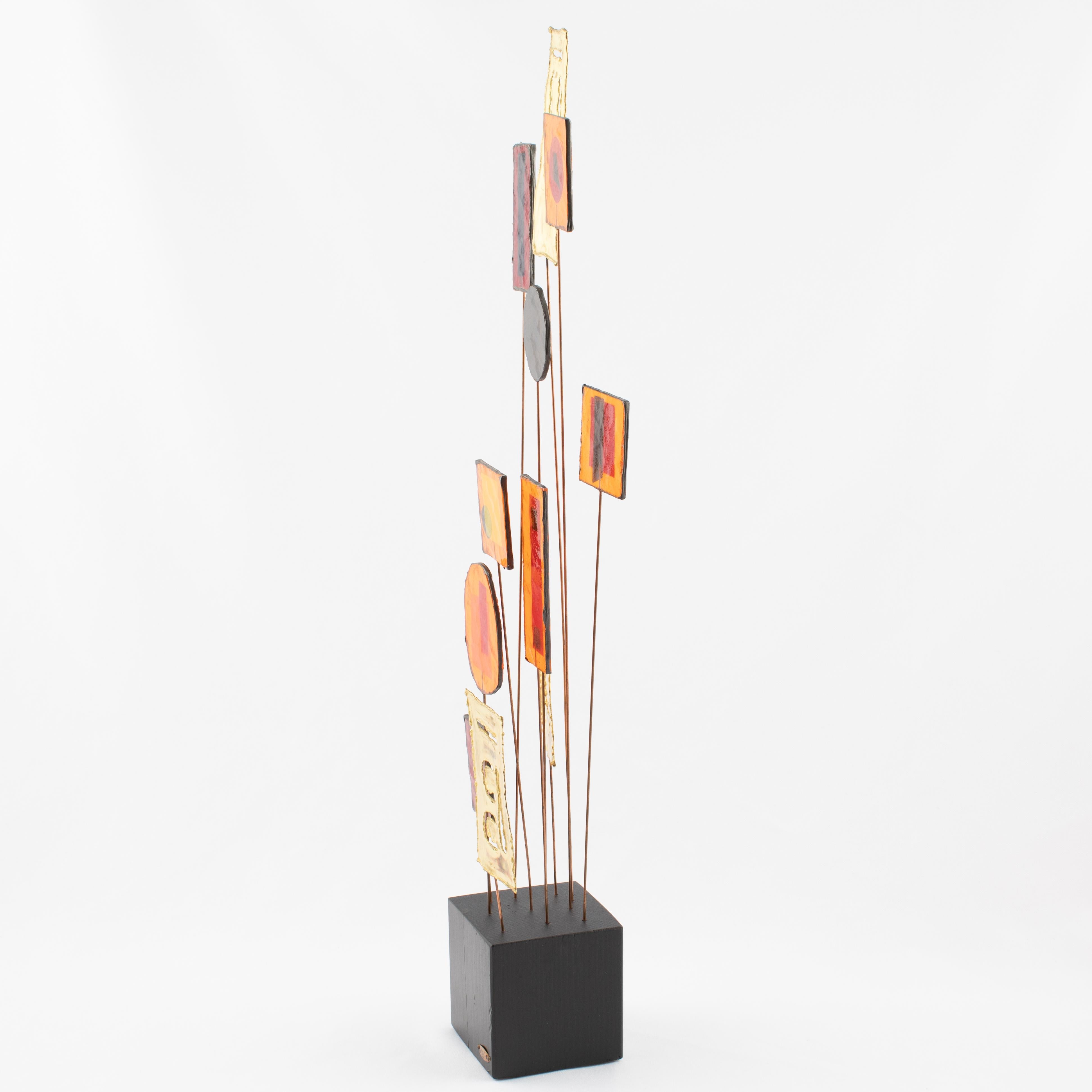 Tabletop sculpture features colorful resin disks and rectangles along with torch-cut brass rectangles supported by copper rods mounted to a black-painted wooden base. Made by Artisan House and signed 