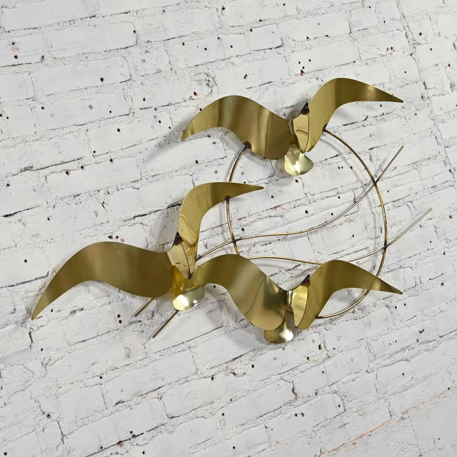 Fabulous brass plated bird or flock of seagull’s wall sculpture signed C. Jere, 1985. Beautiful condition, keeping in mind that this is vintage and not new so will have signs of use and wear. There are two places on the horizontal wires that have