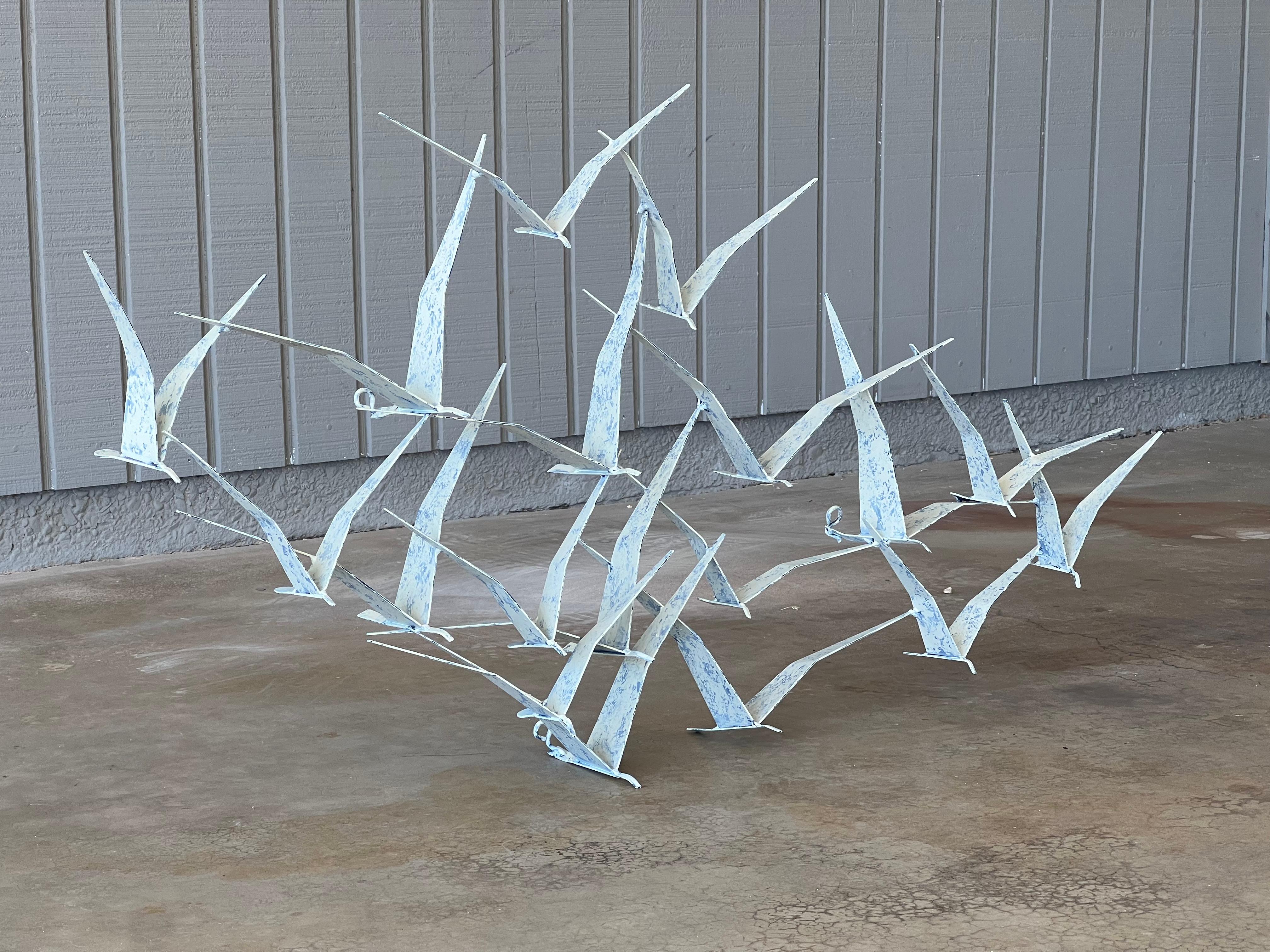 Curtis Jeré “Seagulls” metal wall sculpture in white with blue splatter finish. This design is often referred to as “Birds in Flight”.  It casts some amazing shadows and adds depth and texture to a wall. Measures 43” wide x 22.5” tall x 6” deep.