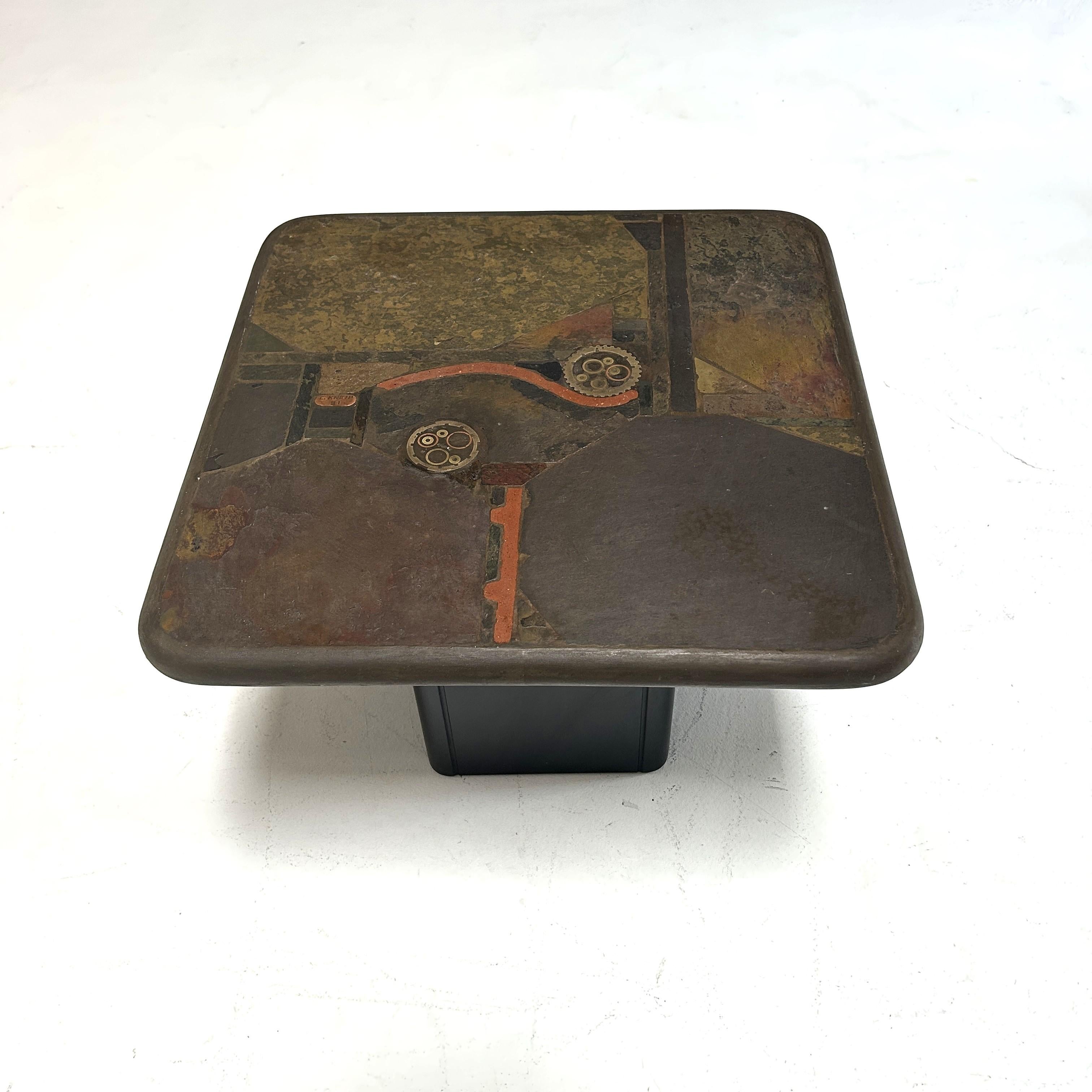 Unique coffe table by C. Kneip

The tabletop is made of Indian slate, various copper and brass elements, and original gears. The base is made of wood and can be dismantled.

With signature on the tabletop and certificate of authenticity.

Please