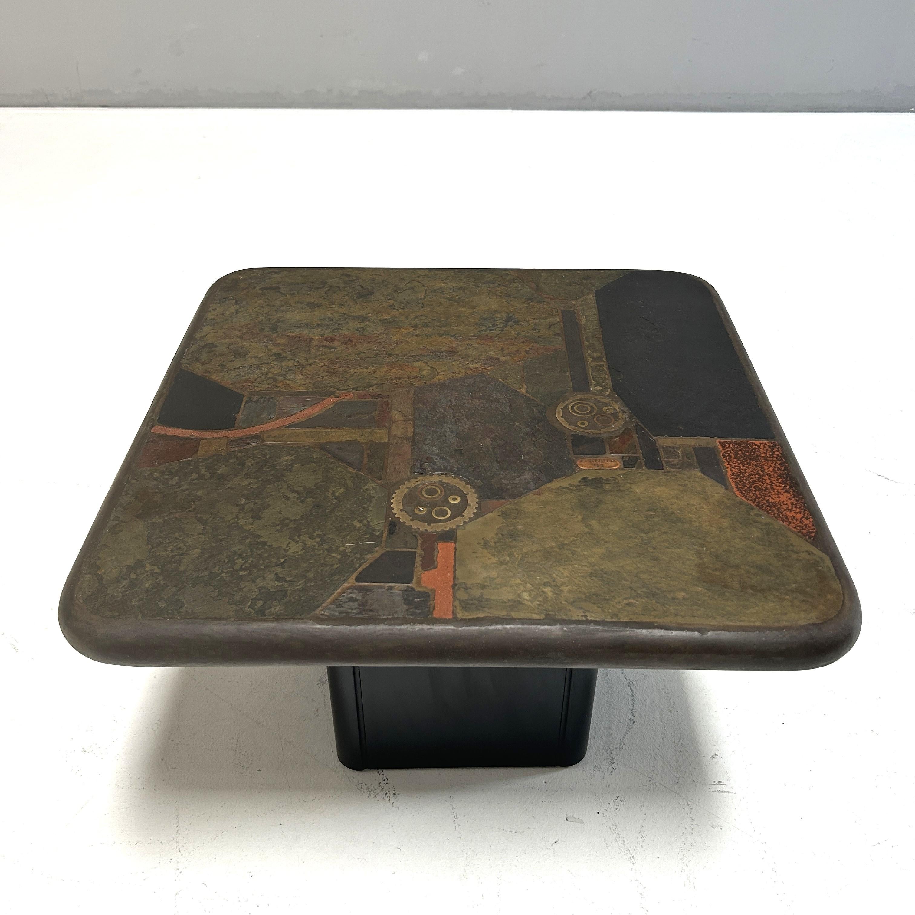 This unique table is made from Indian slate, various copper and brass elements, and original gears. The wooden base can be dismantled.

With signature on the tabletop and certificate of authenticity.

Please also note the second, similar coffee