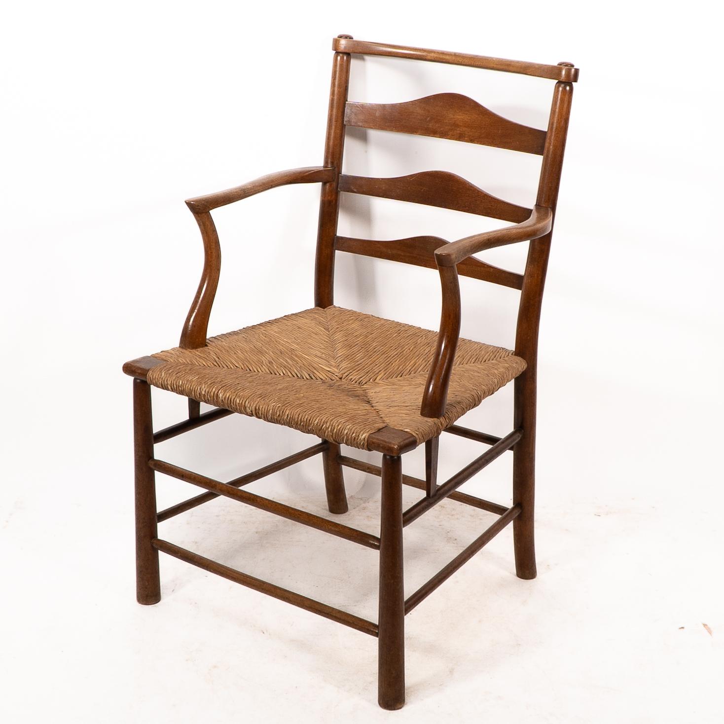 English C R Ashbee. An Arts and Crafts rush seat ladder back armchair For Sale