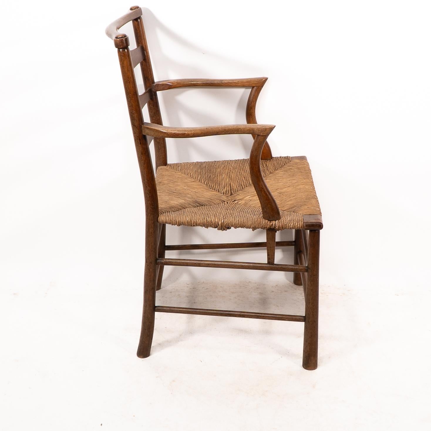 C R Ashbee. An Arts and Crafts rush seat ladder back armchair In Good Condition For Sale In London, GB