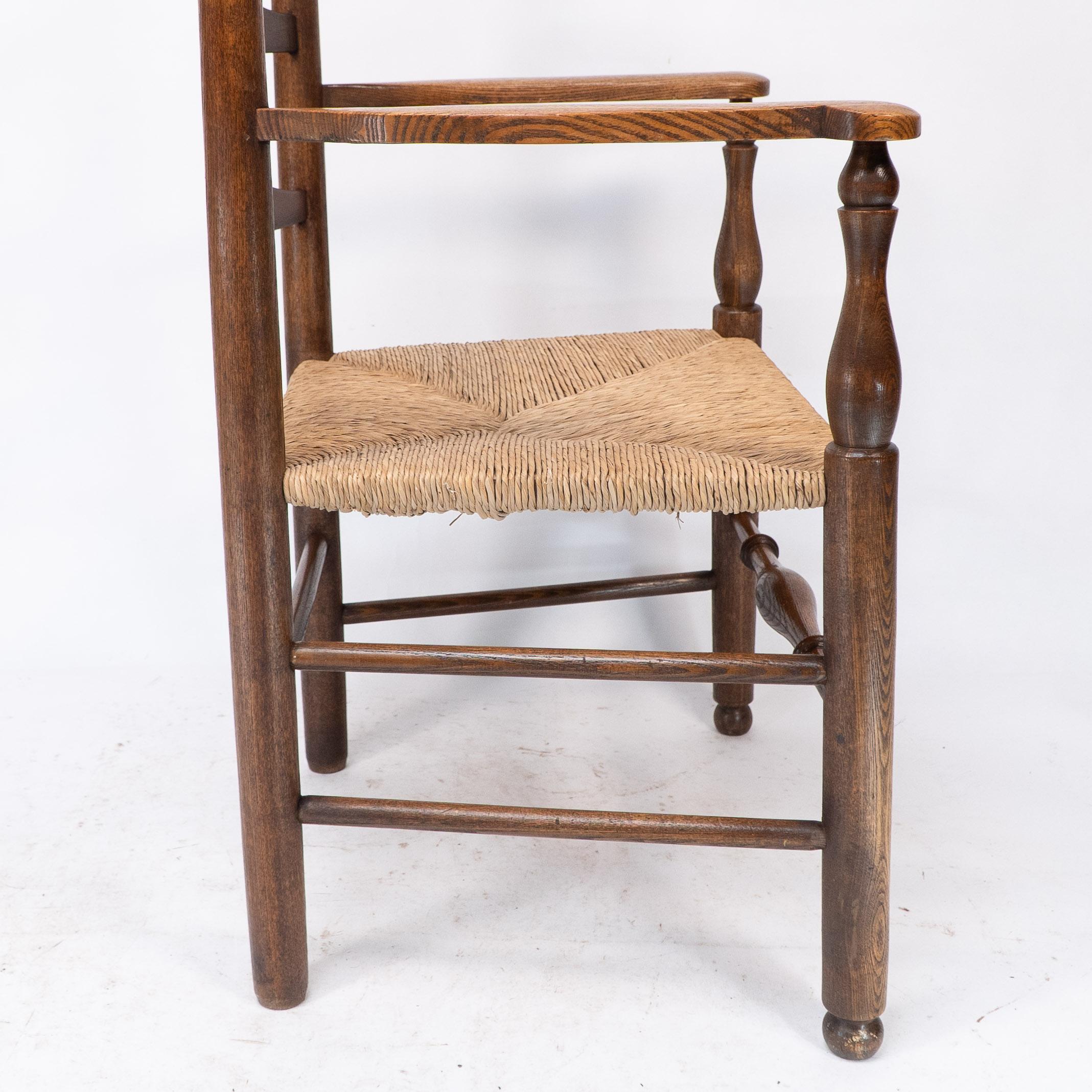 C R Ashbee attr. An Arts & Crafts oak ladder back armchair with re-rushed seat For Sale 2