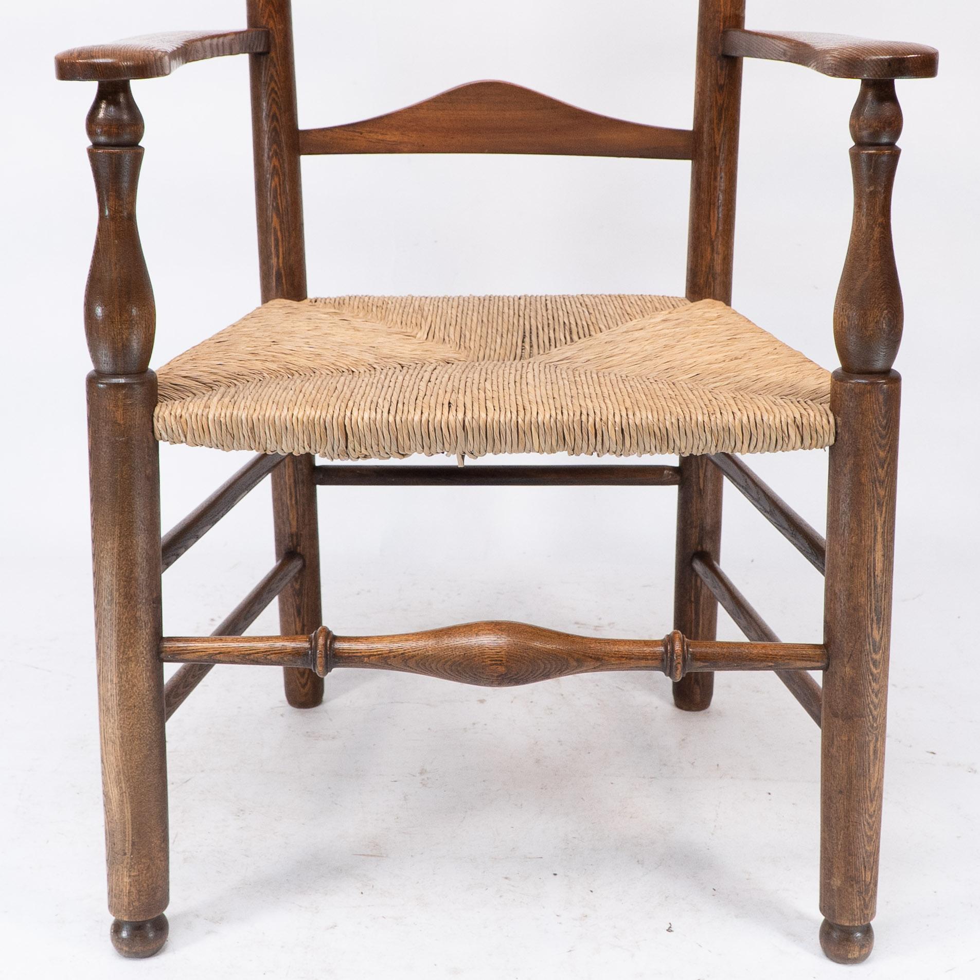 C R Ashbee attr. An Arts & Crafts oak ladder back armchair with re-rushed seat For Sale 4