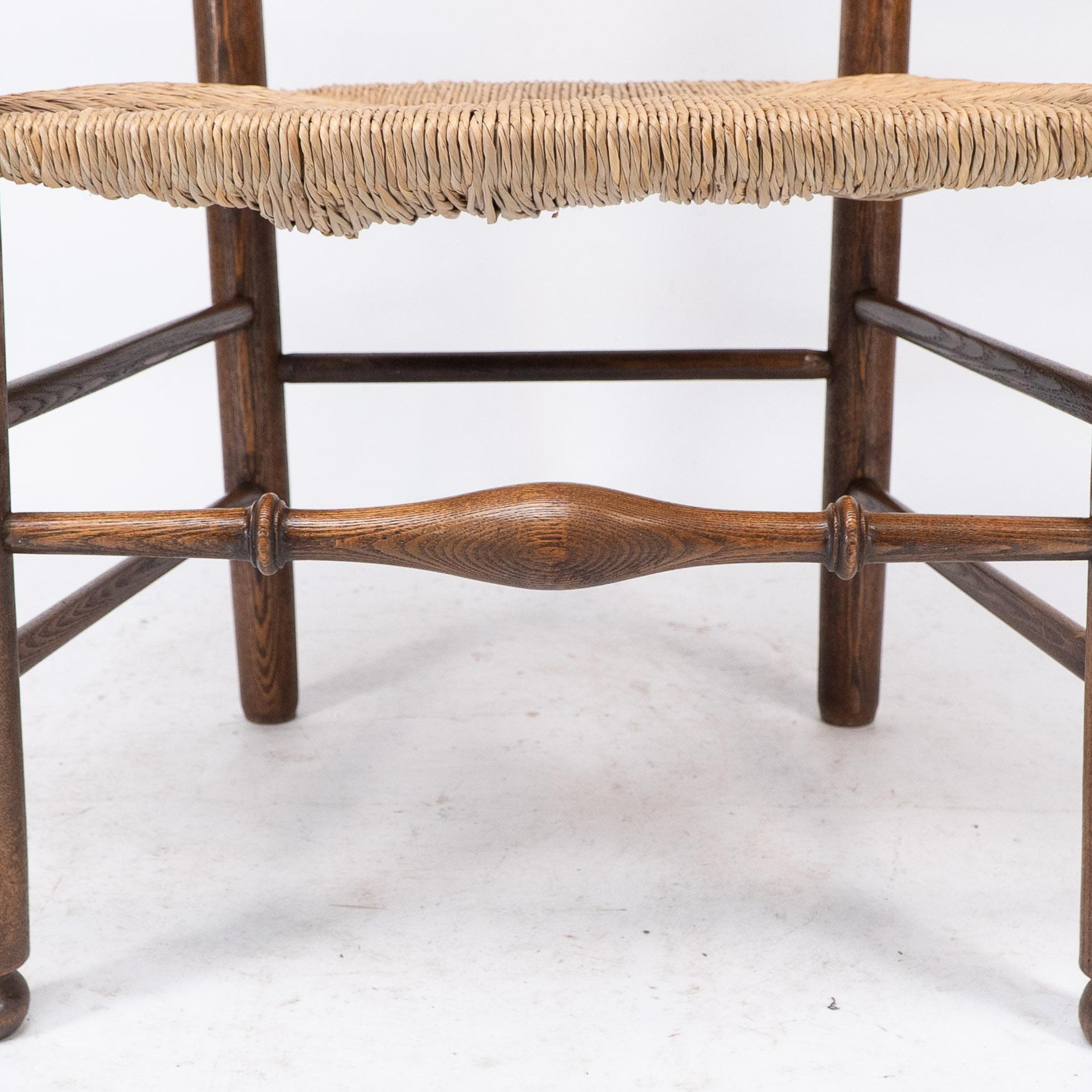 C R Ashbee attr. An Arts & Crafts oak ladder back armchair with re-rushed seat For Sale 5