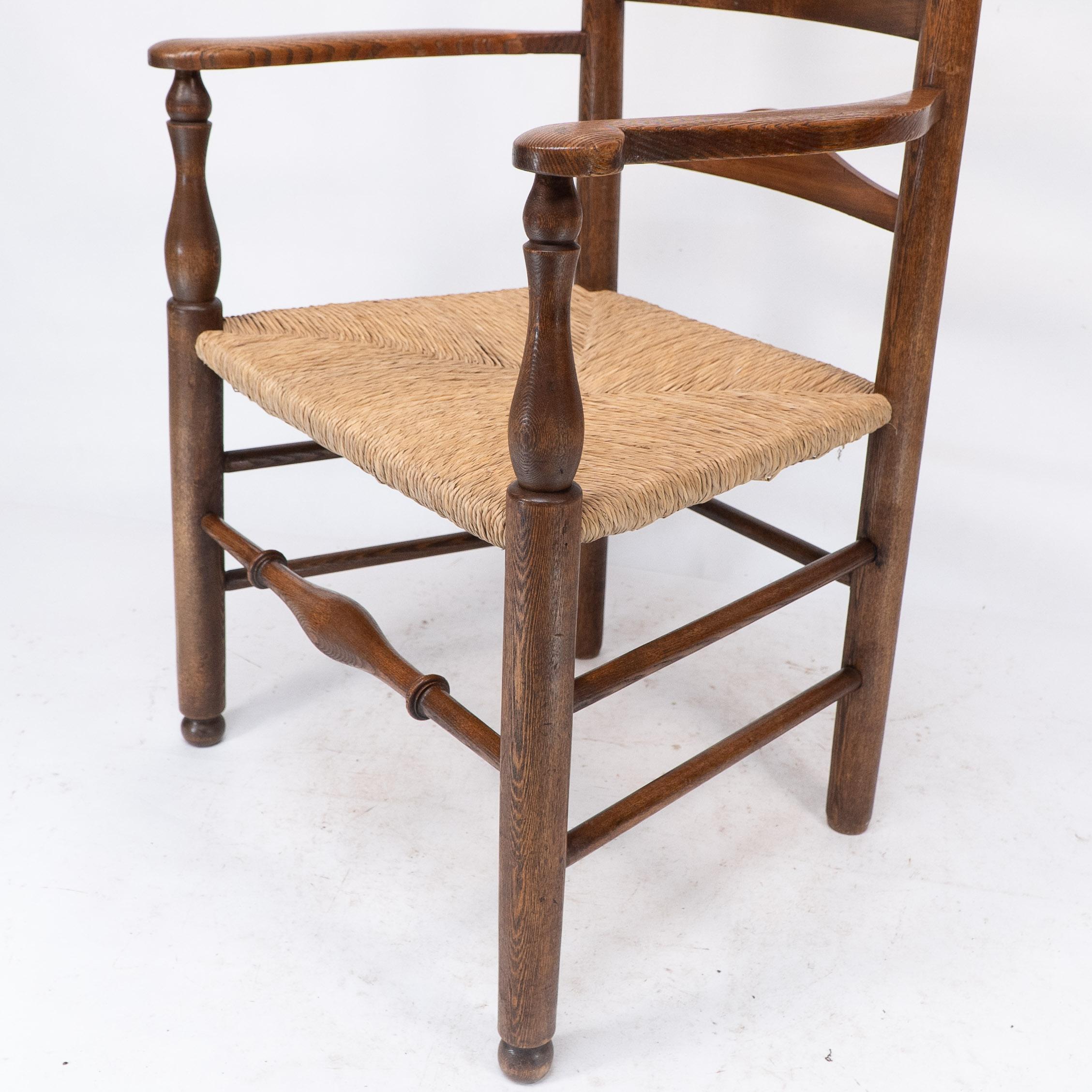 C R Ashbee attr. An Arts & Crafts oak ladder back armchair with re-rushed seat For Sale 6