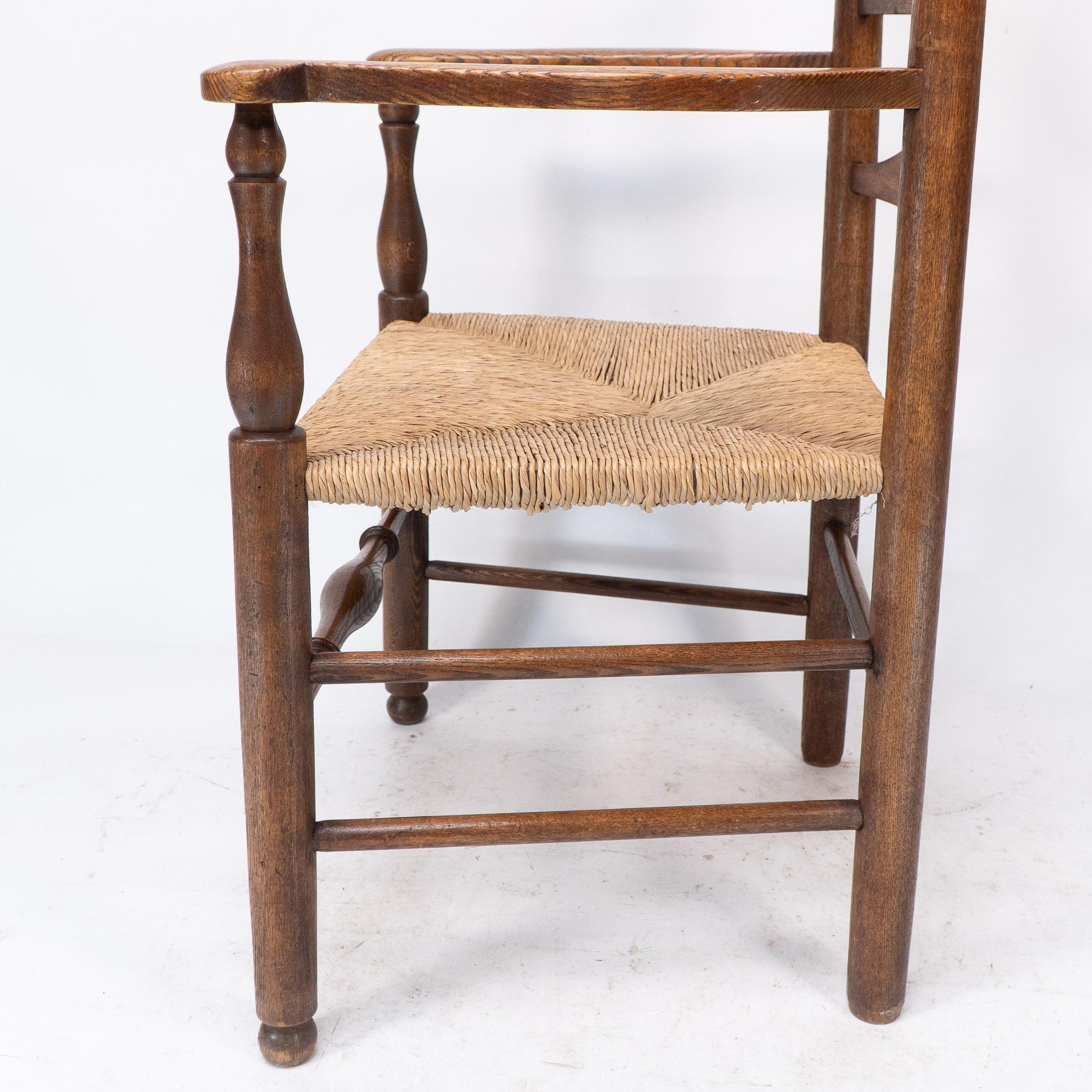 C R Ashbee attr. An Arts & Crafts oak ladder back armchair with re-rushed seat For Sale 7
