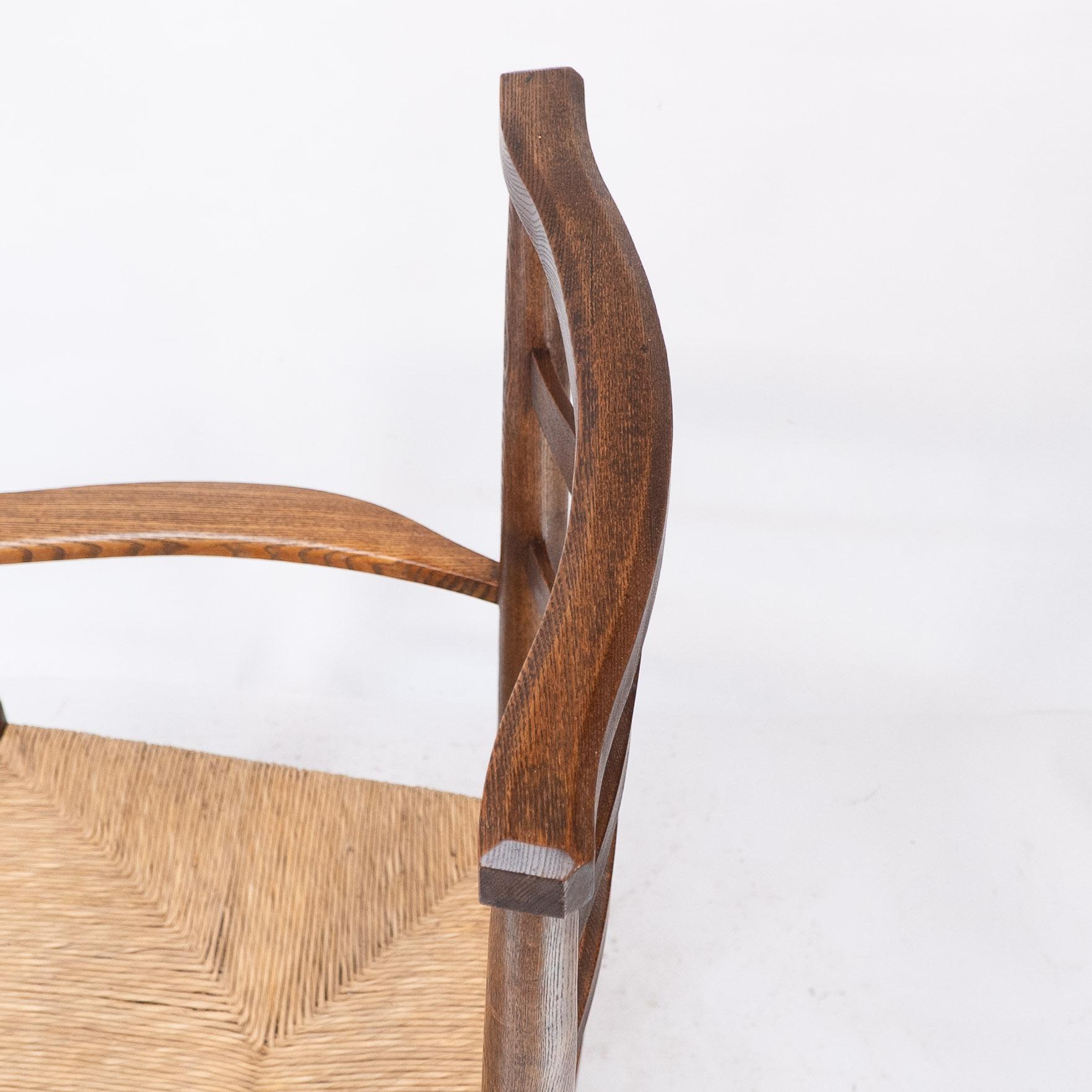 C R Ashbee attr. An Arts & Crafts oak ladder back armchair with re-rushed seat For Sale 8