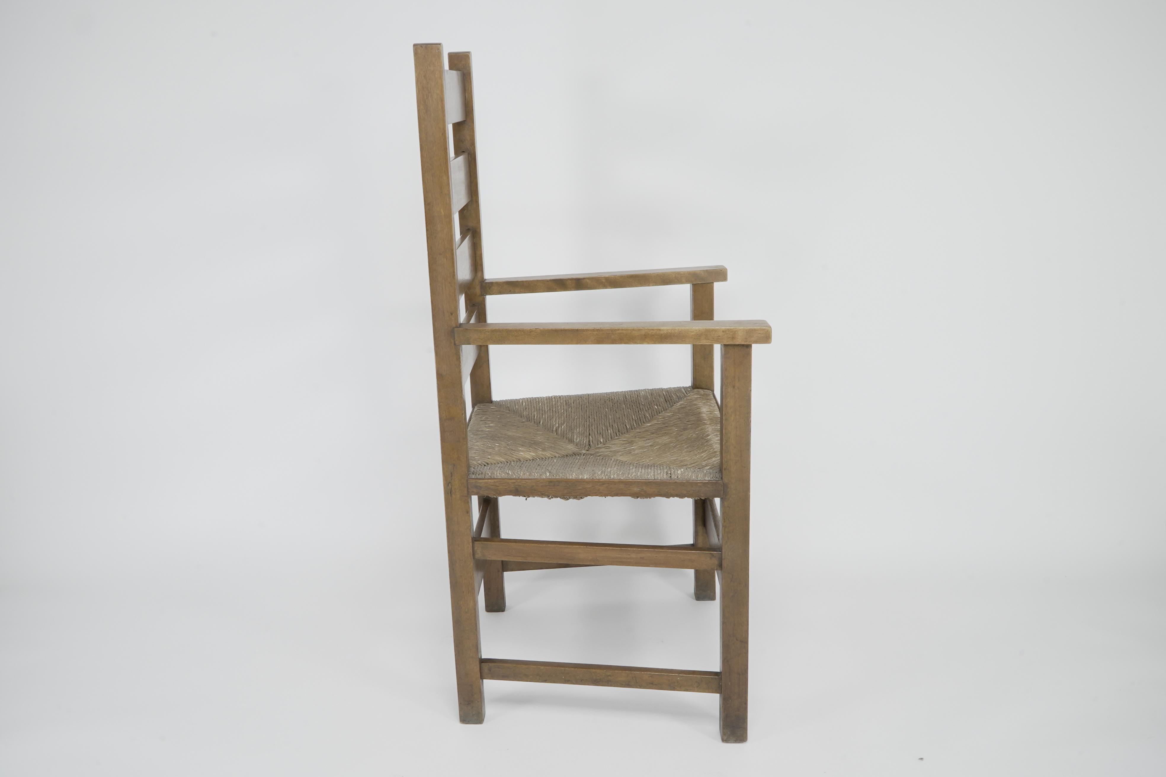 English Baillie Scott for J P White. Arts & Crafts oak & rush seat ladder back armchair. For Sale