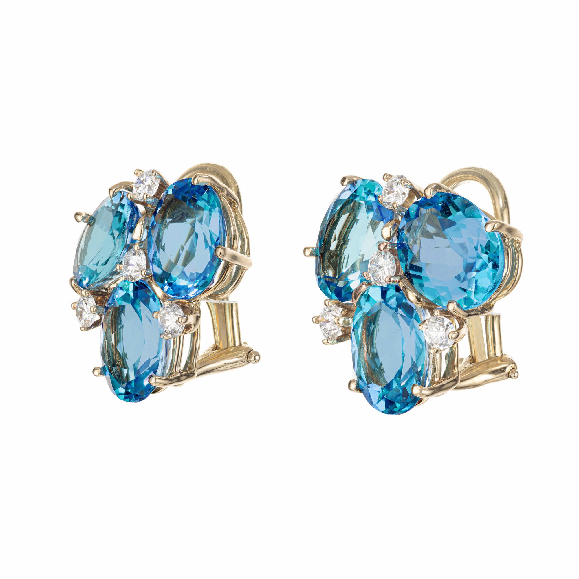 Bright blue topaz and diamond clip post earrings from C. Silvera. 6 oval topaz with 8 round diamond accents set in 18k yellow gold. 

6 oval blue topaz, approx. 10cts
8 round brilliant cut diamonds, G VS SI approx. .40cts
18k yellow gold 
Stamped: