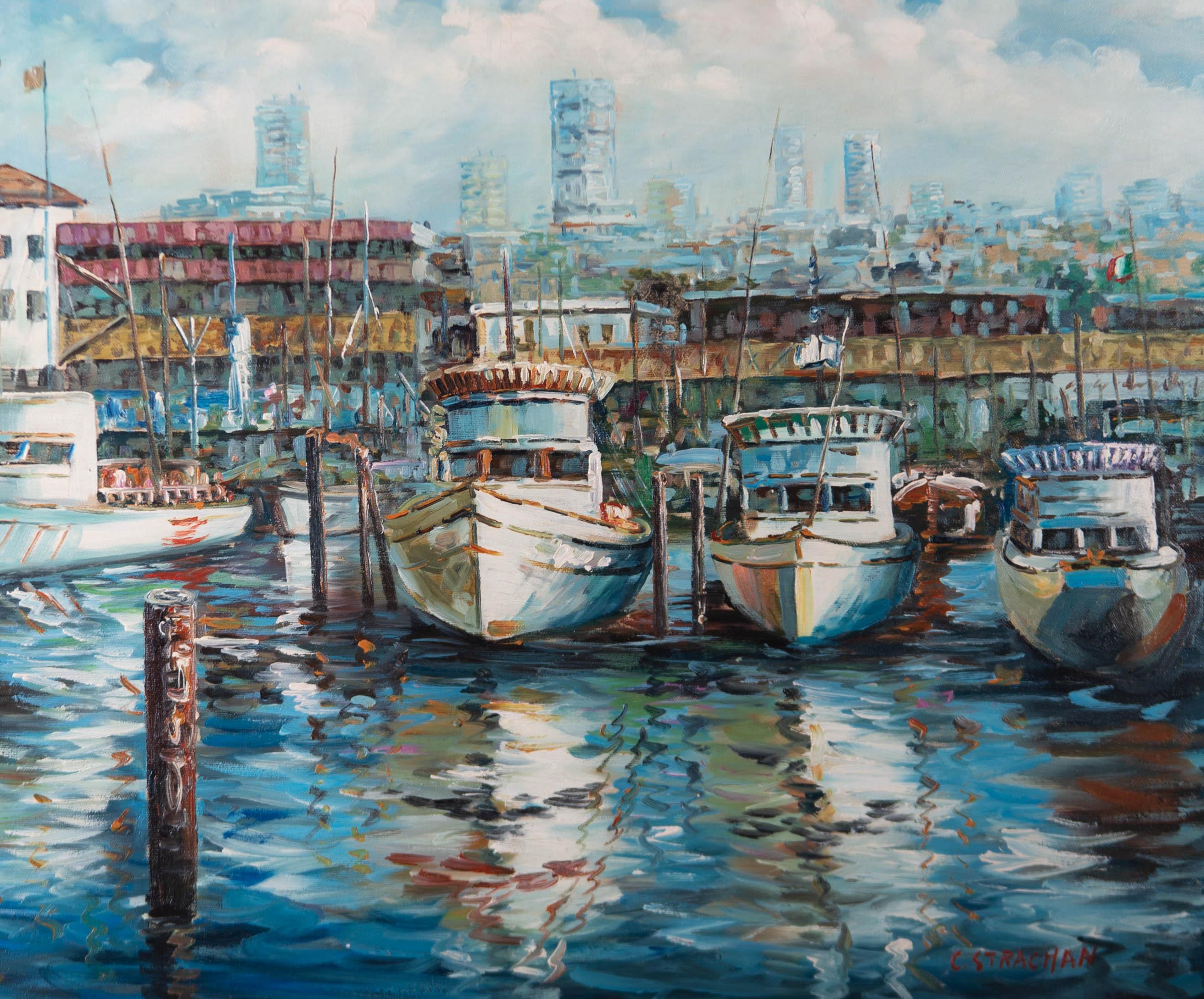 A vibrant oil painting, depicting boats lined up in a harbour. Signed to the lower right-hand corner. Well-presented in an off-white frame, as shown. On canvas on stretchers.
