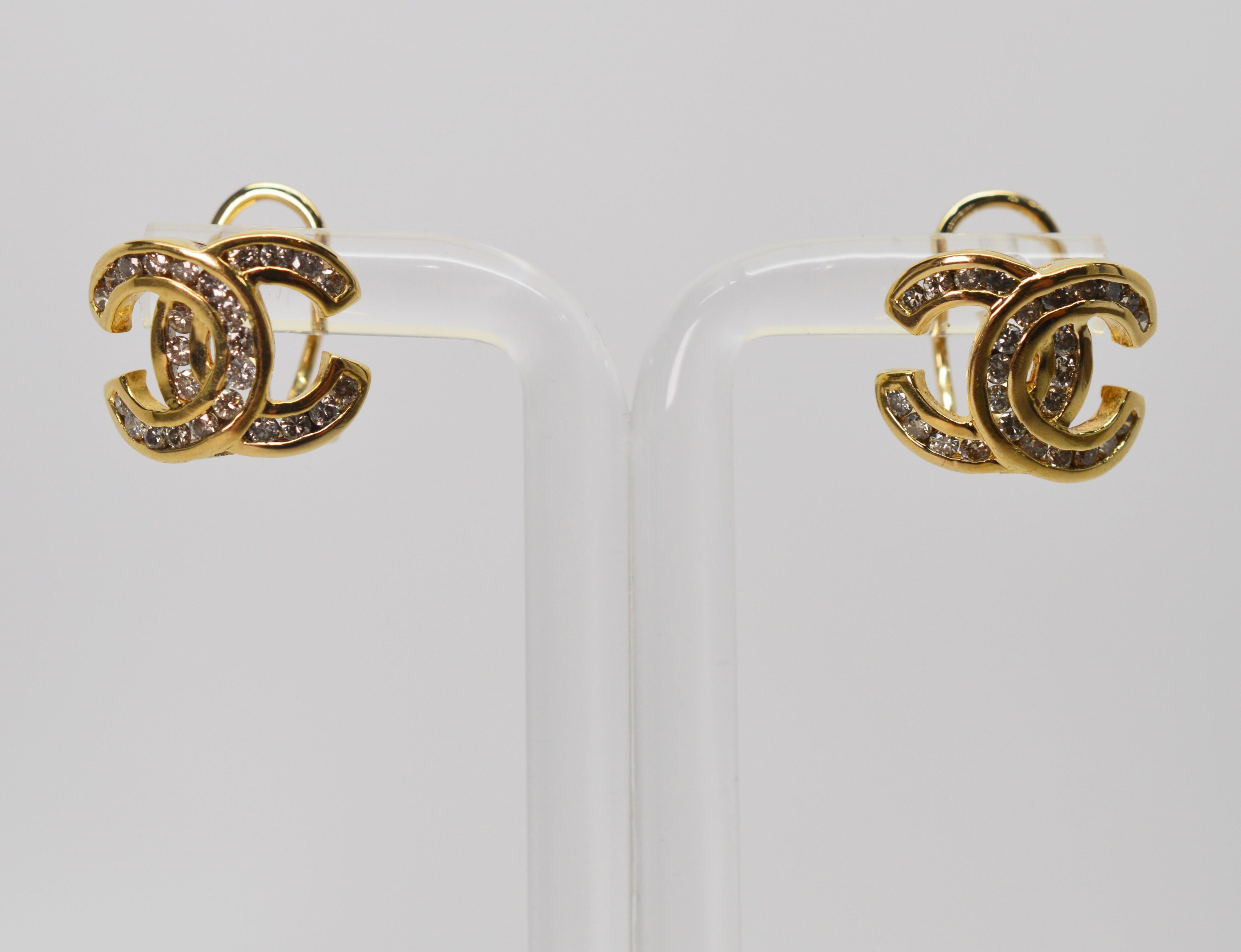 A mirror image letter C, signifying true style in fourteen carat yellow gold and accented with fifty diamonds with a total weight of one half carat make these earrings for pierced ears outfitted with a post and omega clip. In gift box. 