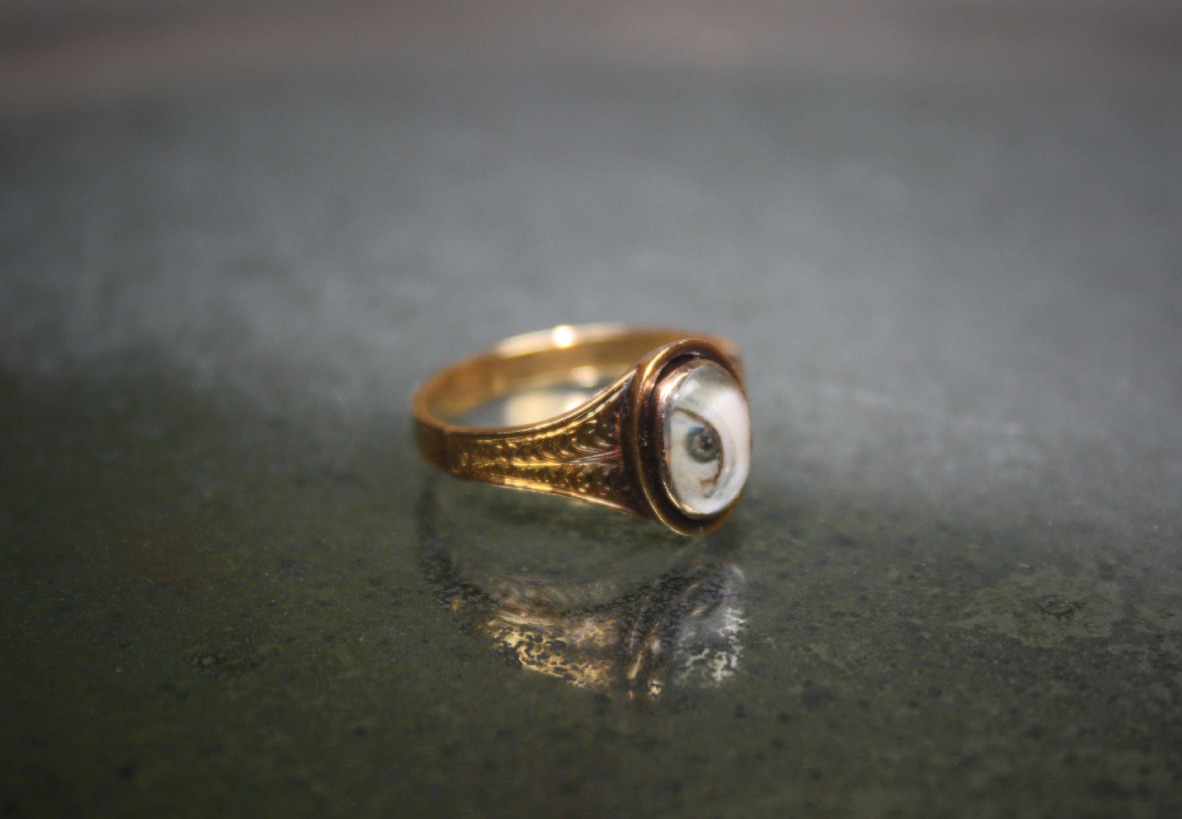 A rare circa 1780 lovers eye ring. Georgian yellow gold ring set with a painted lovers eye miniature under a convex crystal lens. The miniature is of what seems to be females eye. The ring is unmarked no stamps or marks visible (Gold content not